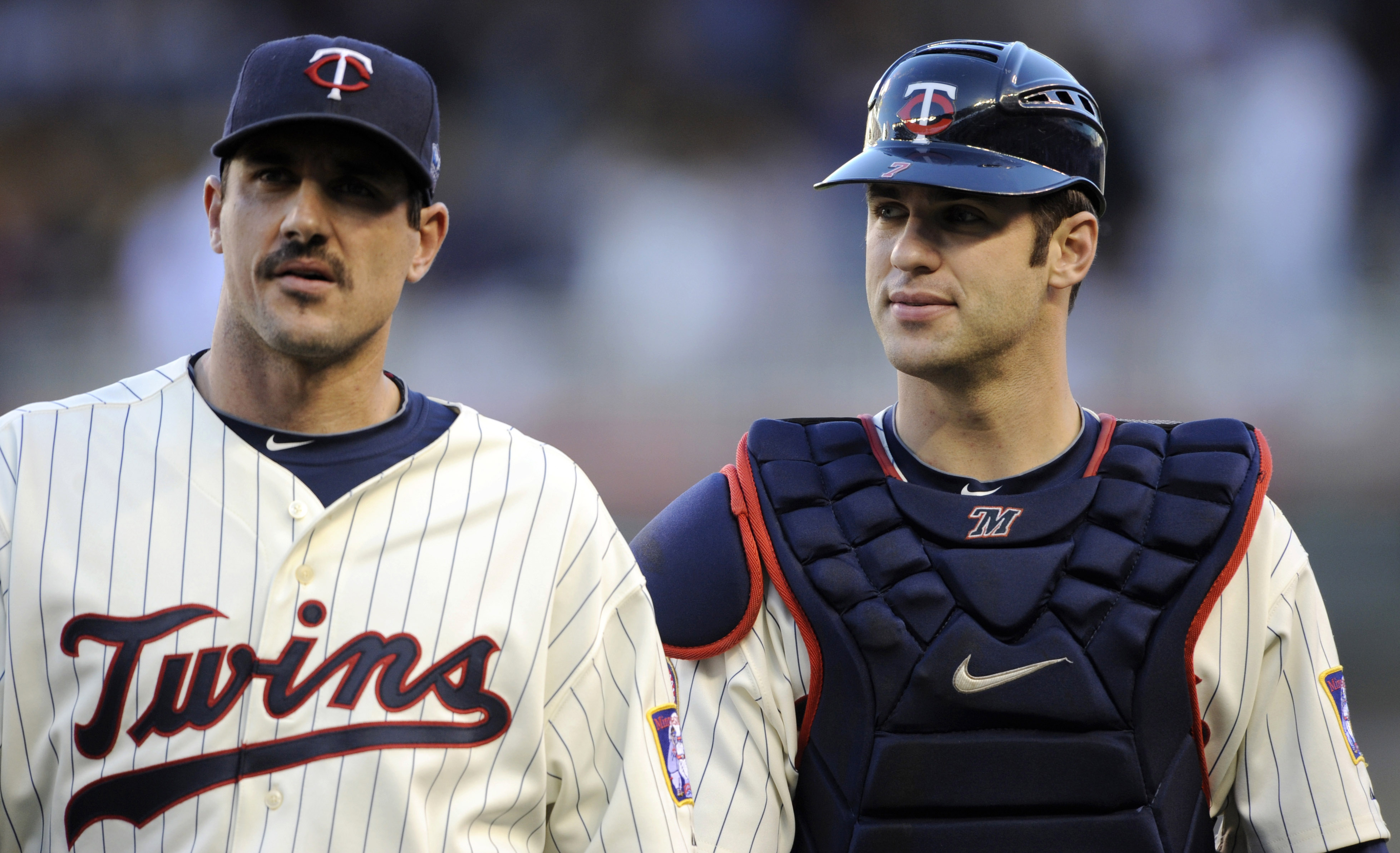 MINNEAPOLIS, MN - OCTOBER 7: Starting pitcher Carl Pavano #48 and catcher Joe Mauer #7 of the Minnesota Twins walk to the dugout prior to game two of the ALDS game against the New York Yankees on October 7, 2010 at Target Field in Minneapolis, Minnesota. 
