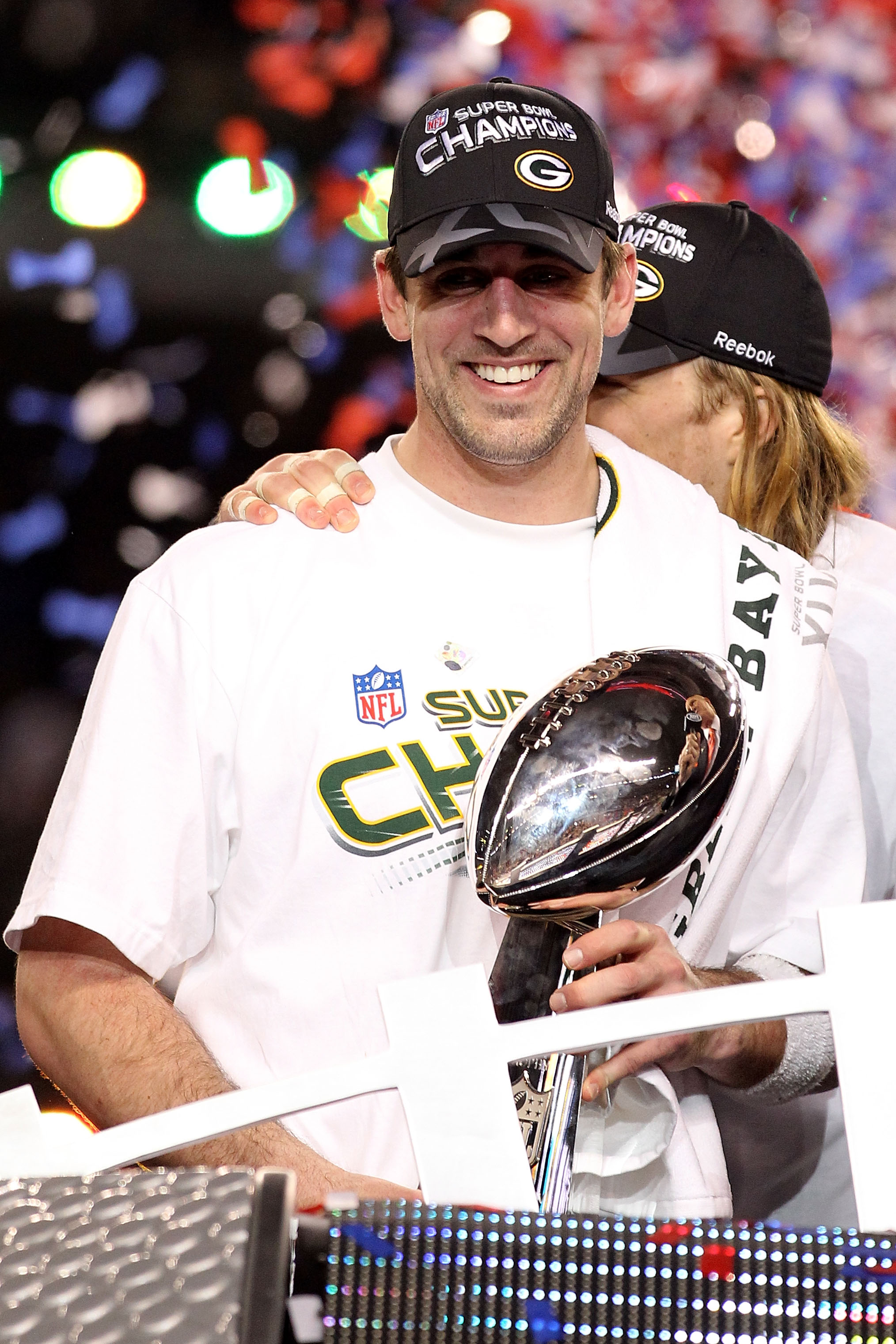 ARLINGTON, TX - FEBRUARY 06:  MVP Aaron Rodgers #12 of the Green Bay Packers celebrates with the Lombardi Trophy after winning Super Bowl XLV against the Pittsburgh Steelers at Cowboys Stadium on February 6, 2011 in Arlington, Texas.  (Photo by Al Bello/G