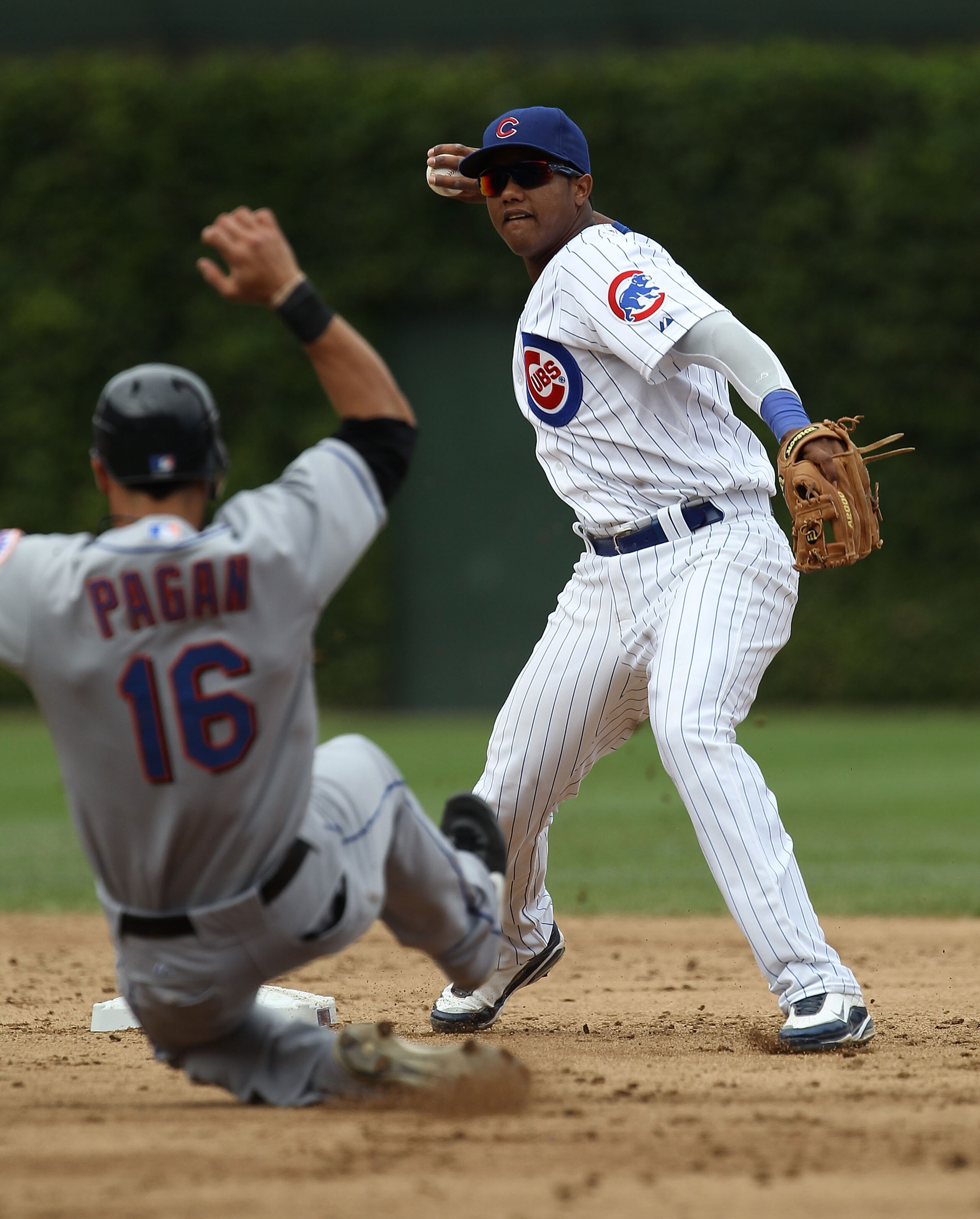 CHICAGO - SEPTEMBER 05: Starlin Castro #13 of the Chicago Cubs turns a double play as Angel Pagan #16 of the New York Mets slides into 2nd base at Wrigley Field on September 5, 2010 in Chicago, Illinois. (Photo by Jonathan Daniel/Getty Images) CHICAGO - SEPTEMBER 05: Starlin Castro #13 of the Chicago Cubs turns a double play as Angel Pagan #16 of the New York Mets slides into 2nd base at Wrigley Field on September 5, 2010 in Chicago, Illinois. (Photo by Jonathan Daniel/Getty Images)