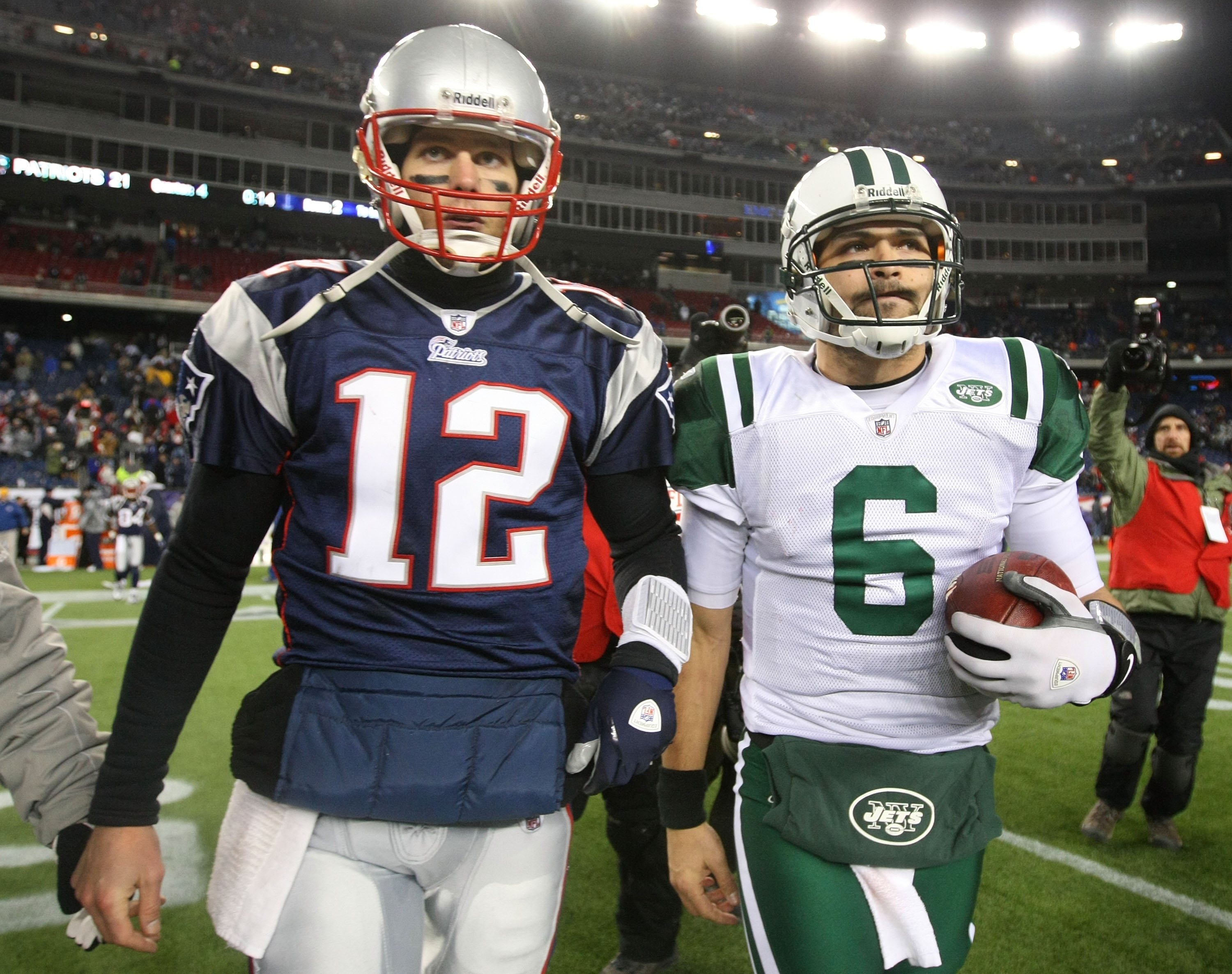 FOXBORO, MA - JANUARY 16:  Tom Brady #12 of the New England Patriots and Mark Sanchez #6 of the New York Jets walk off the field after the Jets defeated the Patriots 28 to 21 their 2011 AFC divisional playoff game at Gillette Stadium on January 16, 2011 i
