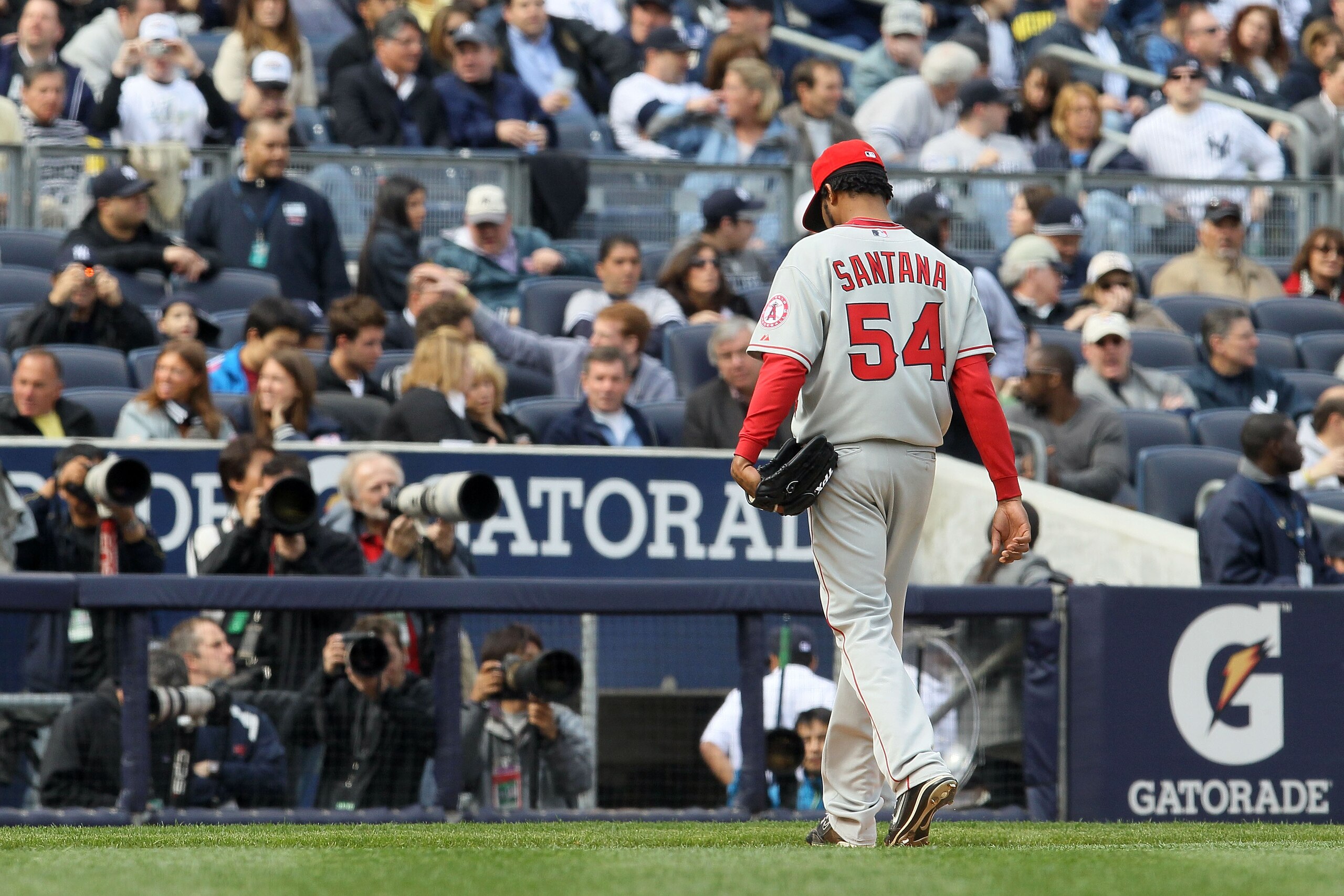 NEW YORK - APRIL 13:  Starting pitcher Ervin Santana #54 of the Los Angeles Angels of Anaheim walks towards the dugout after he was taken out of the game in the bottom of the sixth inning against the New York Yankees during the Yankees home opener at Yank