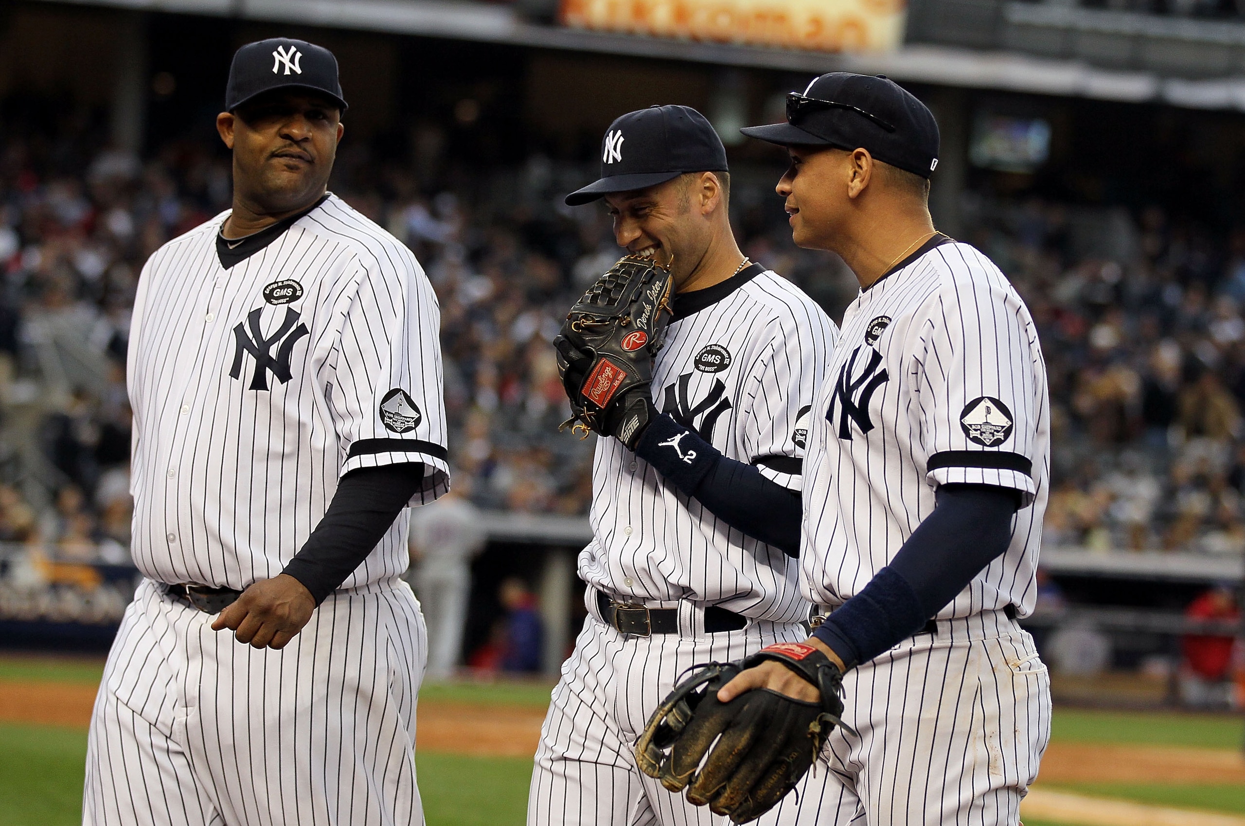 NEW YORK - OCTOBER 20:  (L-R)  CC Sabathia #52, Derek Jeter #2 and Alex Rodriguez #13 of the New York Yankees walk back to the dugout at the end of the top of the fourth inning against the Texas Rangers in Game Five of the ALCS during the 2010 MLB Playoff
