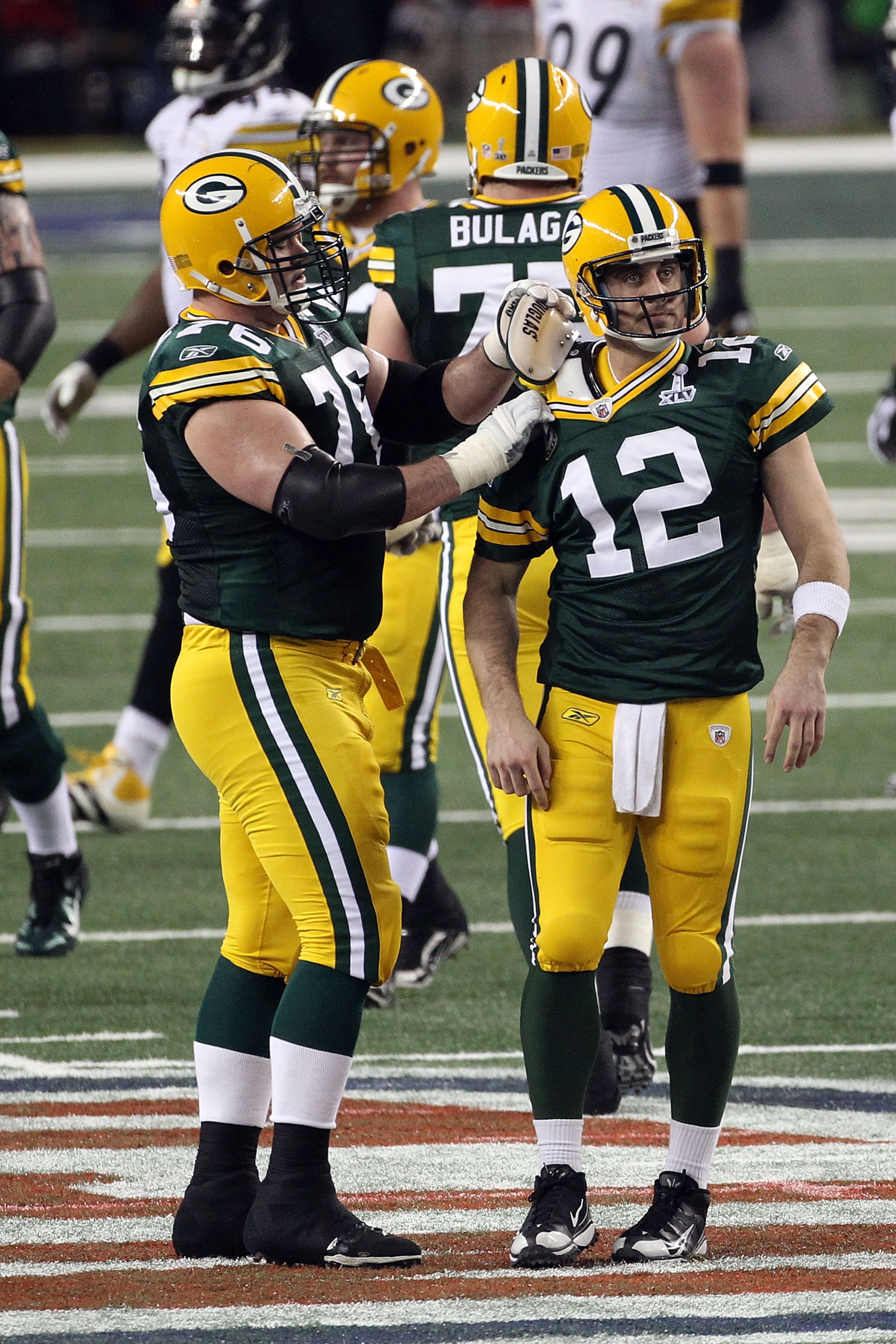 ARLINGTON, TX - FEBRUARY 06: Chad Clifton #76 of the Green Bay Packers fixes teammate Aaron Rodgers #12 shoulder pad during Super Bowl XLV against the Pittsburgh Steelers at Cowboys Stadium on February 6, 2011 in Arlington, Texas. (Photo by Streeter Leck ARLINGTON, TX - FEBRUARY 06: Chad Clifton #76 of the Green Bay Packers fixes teammate Aaron Rodgers #12 shoulder pad during Super Bowl XLV against the Pittsburgh Steelers at Cowboys Stadium on February 6, 2011 in Arlington, Texas. (Photo by Streeter Leck