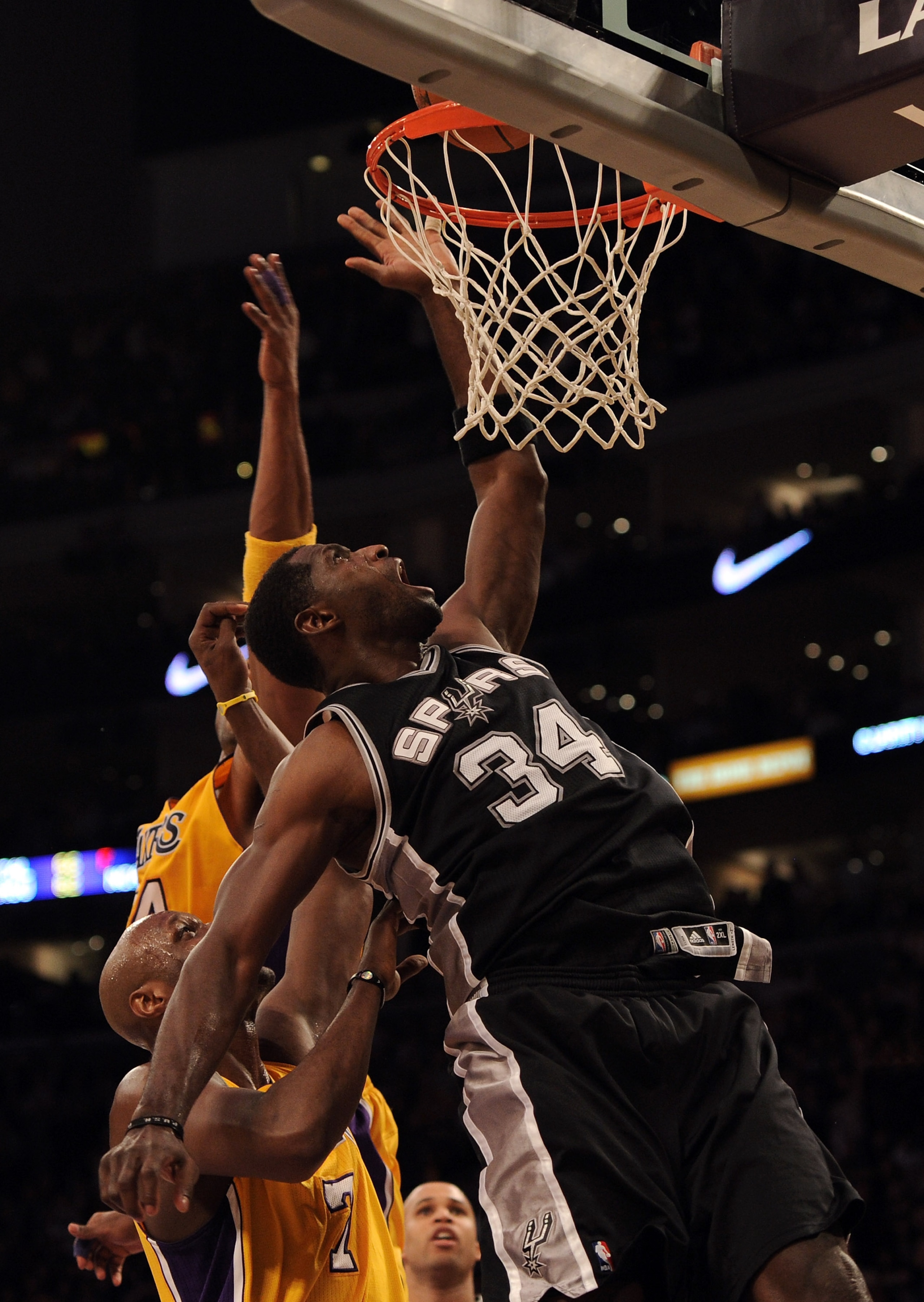 LOS ANGELES, CA - FEBRUARY 03:  Antonio McDyess #34 of the San Antonio Spurs tips in the winning basket in front of Lamar Odum #7 and Kobe Bryant #24 of the Los Angeles Lakers for a 89-88 win during the fourth quarter at Staples Center on February 3, 2011