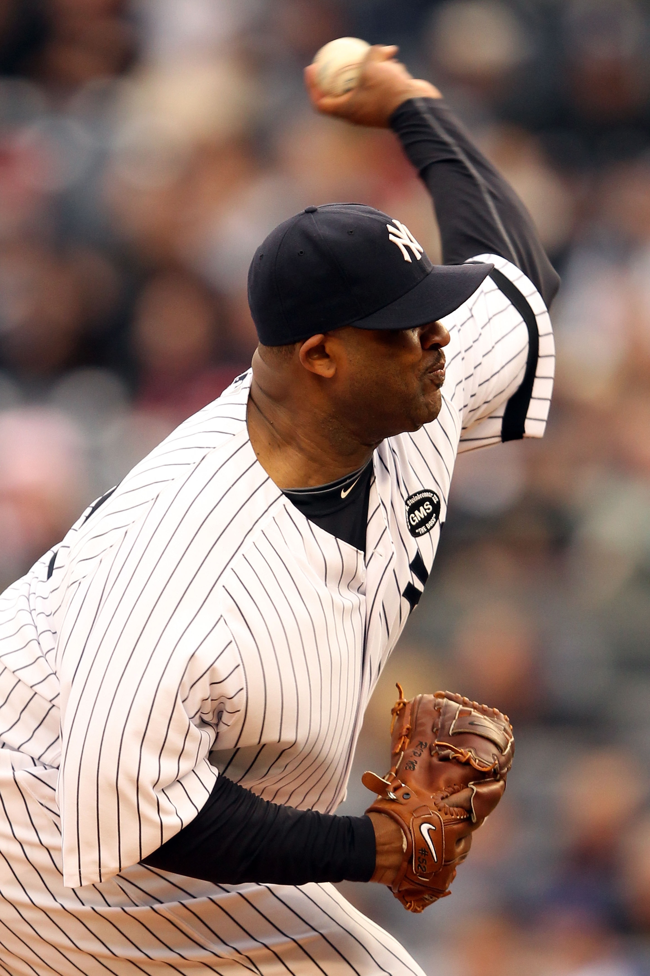 NEW YORK - OCTOBER 20:  CC Sabathia #52 of the New York Yankees pitches against the Texas Rangers in Game Five of the ALCS during the 2010 MLB Playoffs at Yankee Stadium on October 20, 2010 in the Bronx borough of New York City.  (Photo by Al Bello/Getty