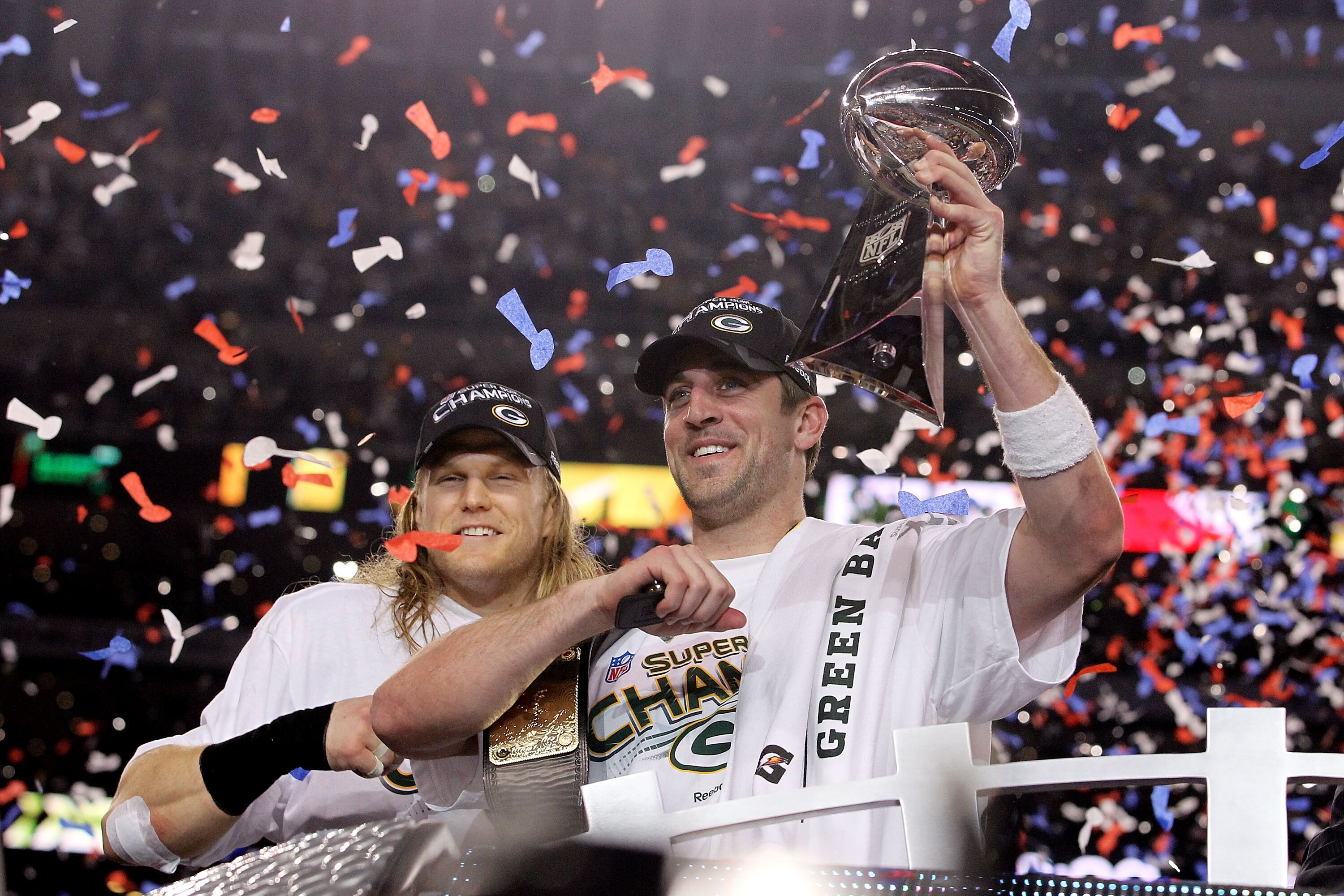 ARLINGTON, TX - FEBRUARY 06:  Aaron Rodgers #12 and Clay Matthews #52 of the Green Bay Packers of the Green Bay Packers holds the Lombardi Trophy after defeating the Pittsburgh Steelers 31-25 during Super Bowl XLV at Cowboys Stadium on February 6, 2011 in