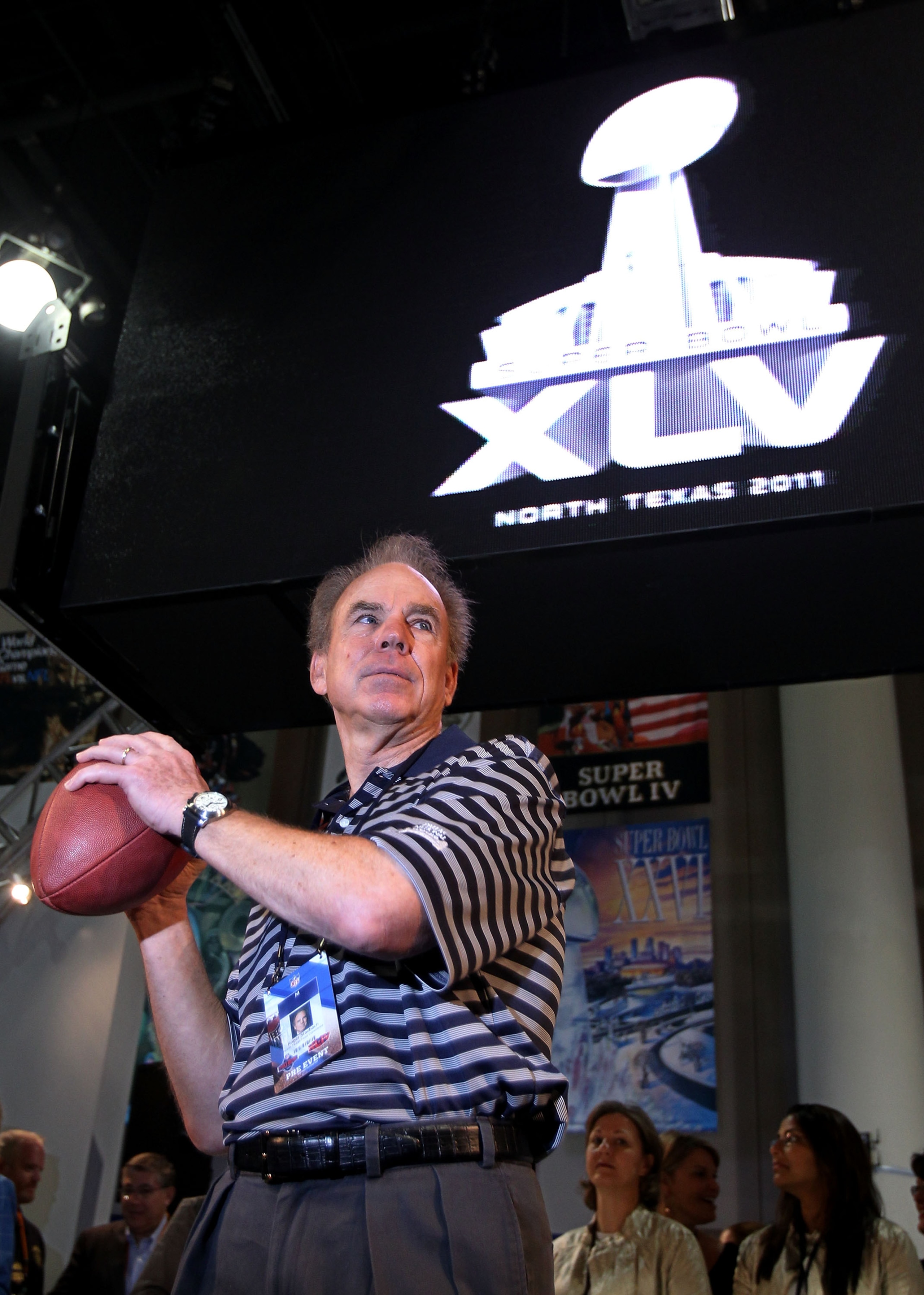 FORT LAUDERDALE, FL - FEBRUARY 04:  Roger Staubach, former NFL quarterback, throws a football as the new Super Bowl logo is unvieled during a press conference held at the Fort Lauderdale Convention Center as part of media week for Super Bowl XLIV on Febru