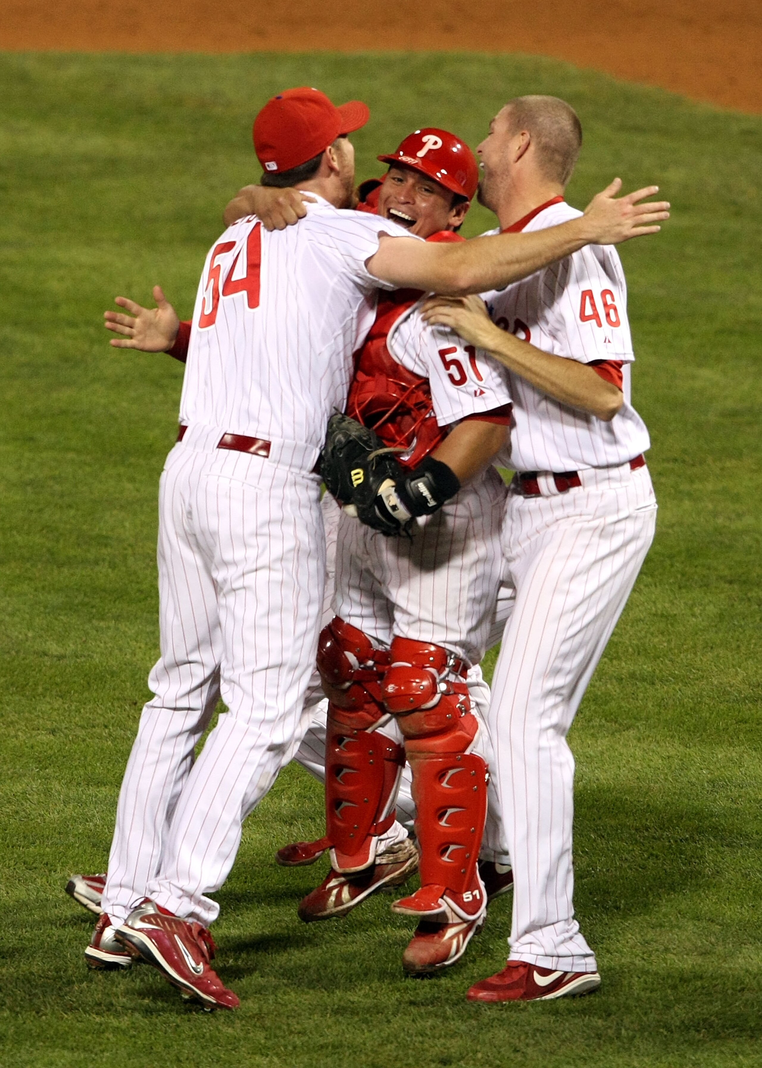 PHILADELPHIA - OCTOBER 21:  Brad Lidge #54, Ryan Madson #46 and Carlos Ruiz #51 of the Philadelphia Phillies celebrate defeating the Los Angeles Dodgers 10-4 to advance to the World Series in Game Five of the NLCS during the 2009 MLB Playoffs at Citizens