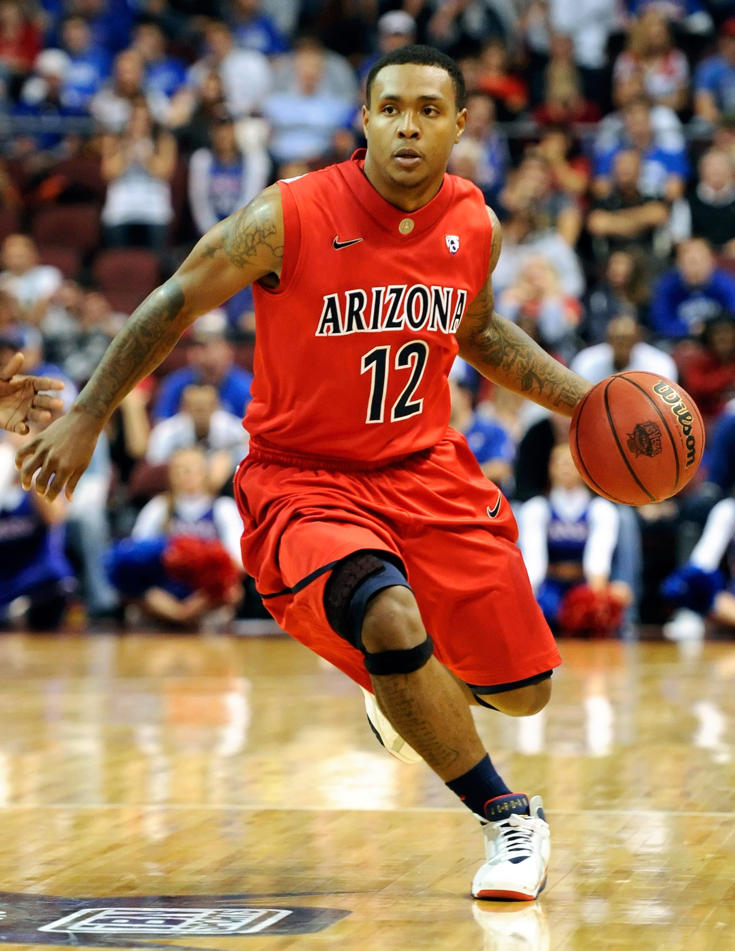 LAS VEGAS - NOVEMBER 27:  Lamont Jones #12 of the Arizona Wildcats drives against the Kansas Jayhawks during the championship game of the Las Vegas Invitational at The Orleans Arena November 27, 2010 in Las Vegas, Nevada. Kansas won 87-79.  (Photo by Etha