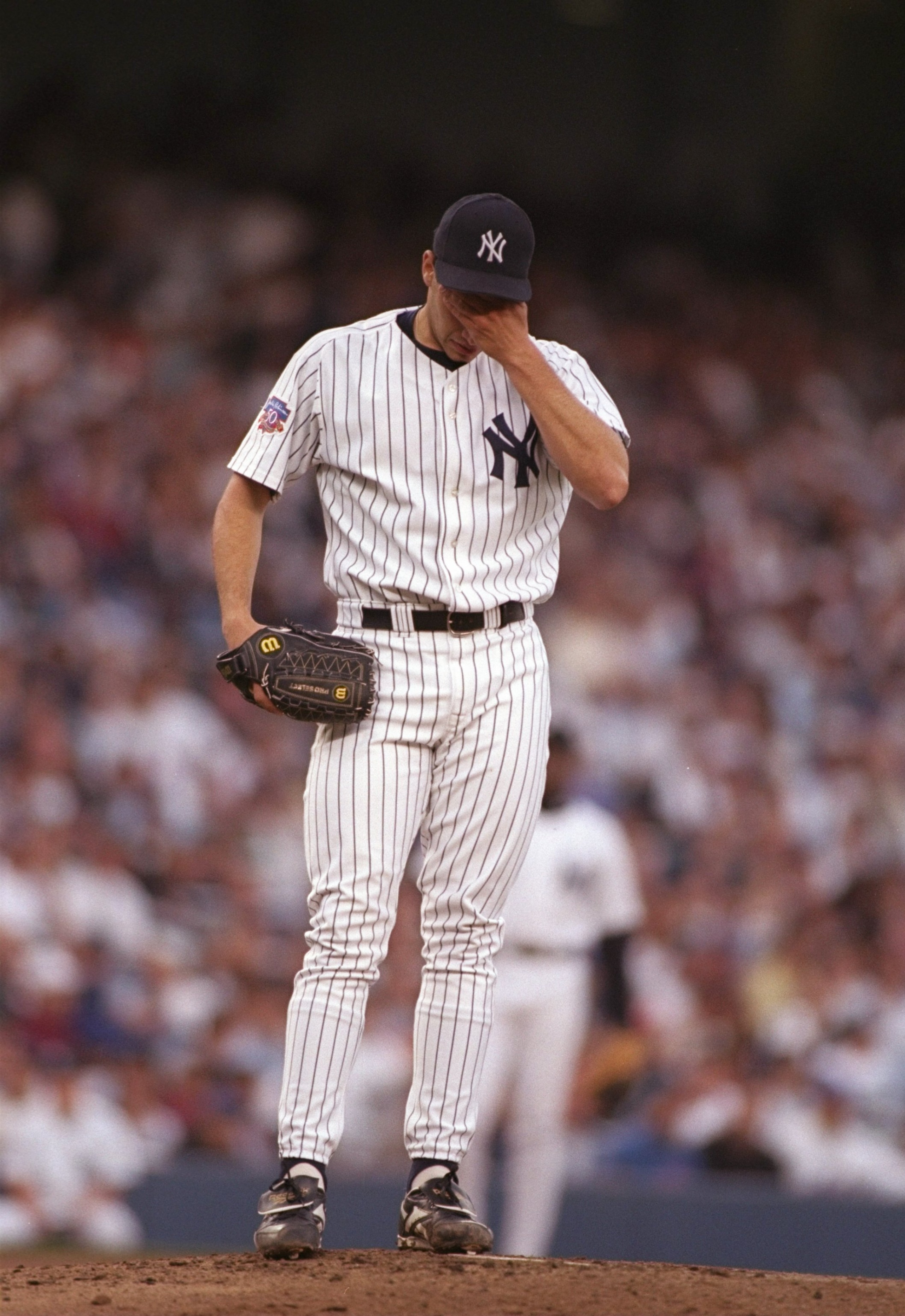 16 Jun 1997:  Pitcher Andy Pettitte of the New York Yankees holds his head down after being rocked during a game against the New York Mets at Yankee Stadium in Bronx, New York.  The Mets won the game 6-0. Mandatory Credit: Al Bello  /Allsport