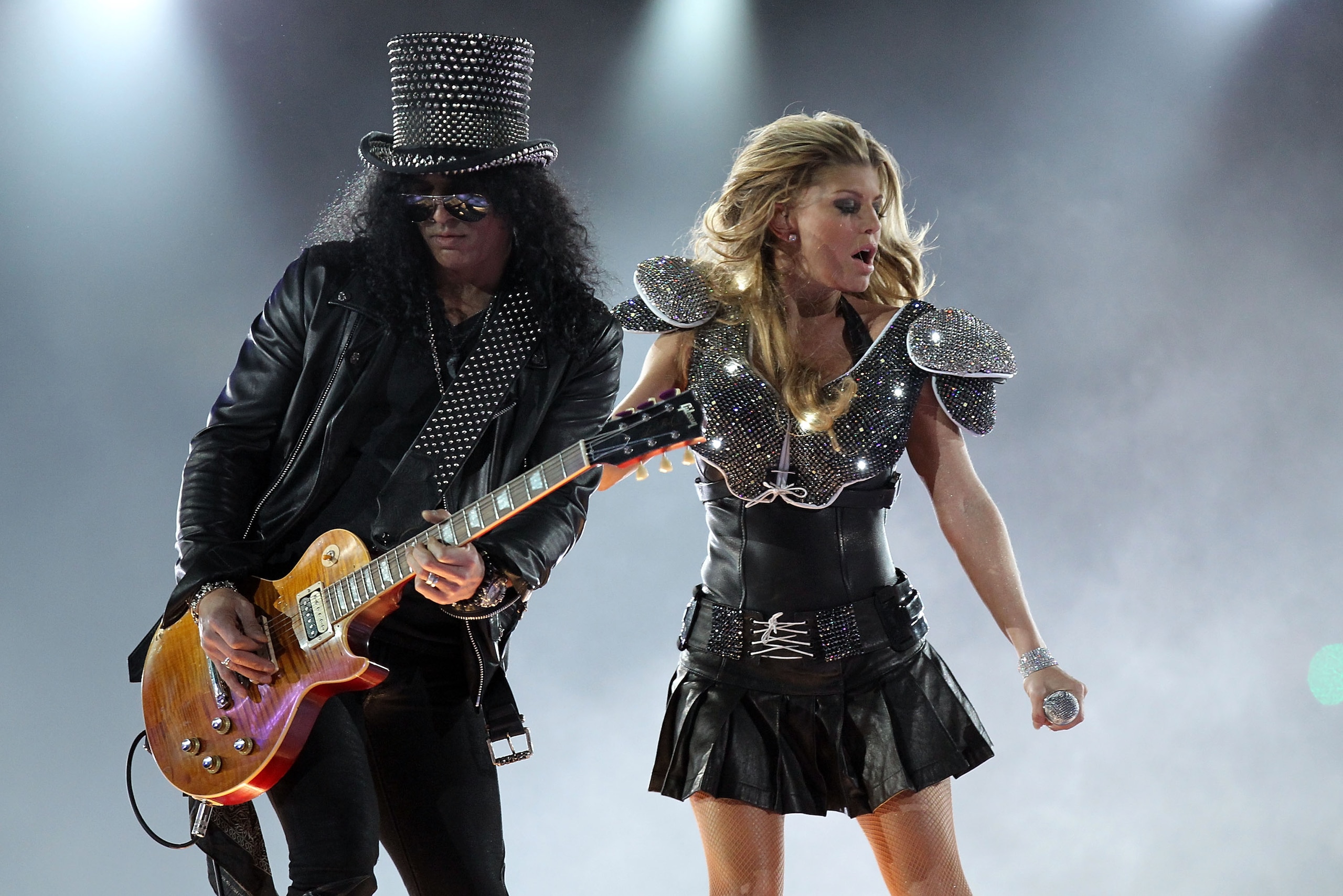 ARLINGTON, TX - FEBRUARY 06:  Fergie of the Black Eyed Peas and Slash perform during the Bridgestone Super Bowl XLV Halftime Show at Cowboys Stadium on February 6, 2011 in Arlington, Texas.  (Photo by Ronald Martinez/Getty Images)
