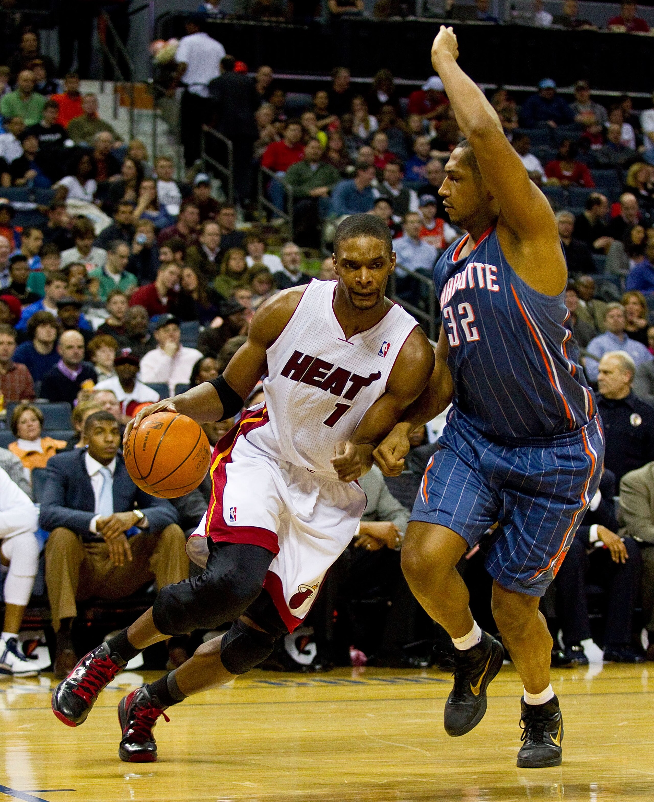 CHARLOTTE, NC - FEBRUARY 04:  Chris Bosh #1 of thre Miami Heat drives the baseline past Boris Diaw #32 of the Charlotte Bobcats at the Time Warner Cable Arena on February 4, 2011 in Charlotte, North Carolina.  The Heat defeated the Bobcats 109-97.  NOTE T