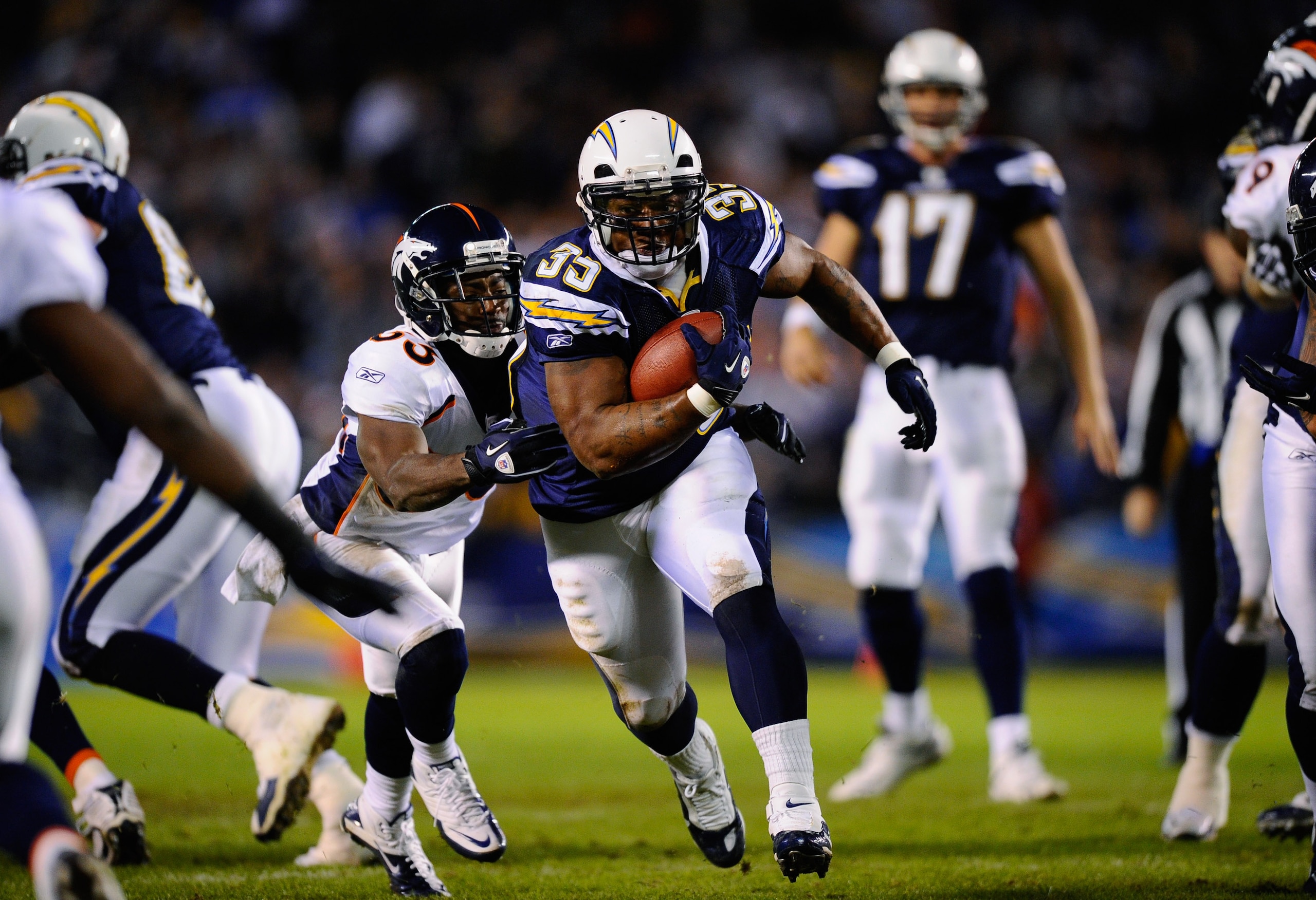 SAN DIEGO - NOVEMBER 22:  Mike Tolbert #35 of the San Diego Chargers breaks a tackle against Nate Jones #33 of the Denver Broncos as he rushes for a gain at Qualcomm Stadium on November 22, 2010 in San Diego, California.  (Photo by Kevork Djansezian/Getty