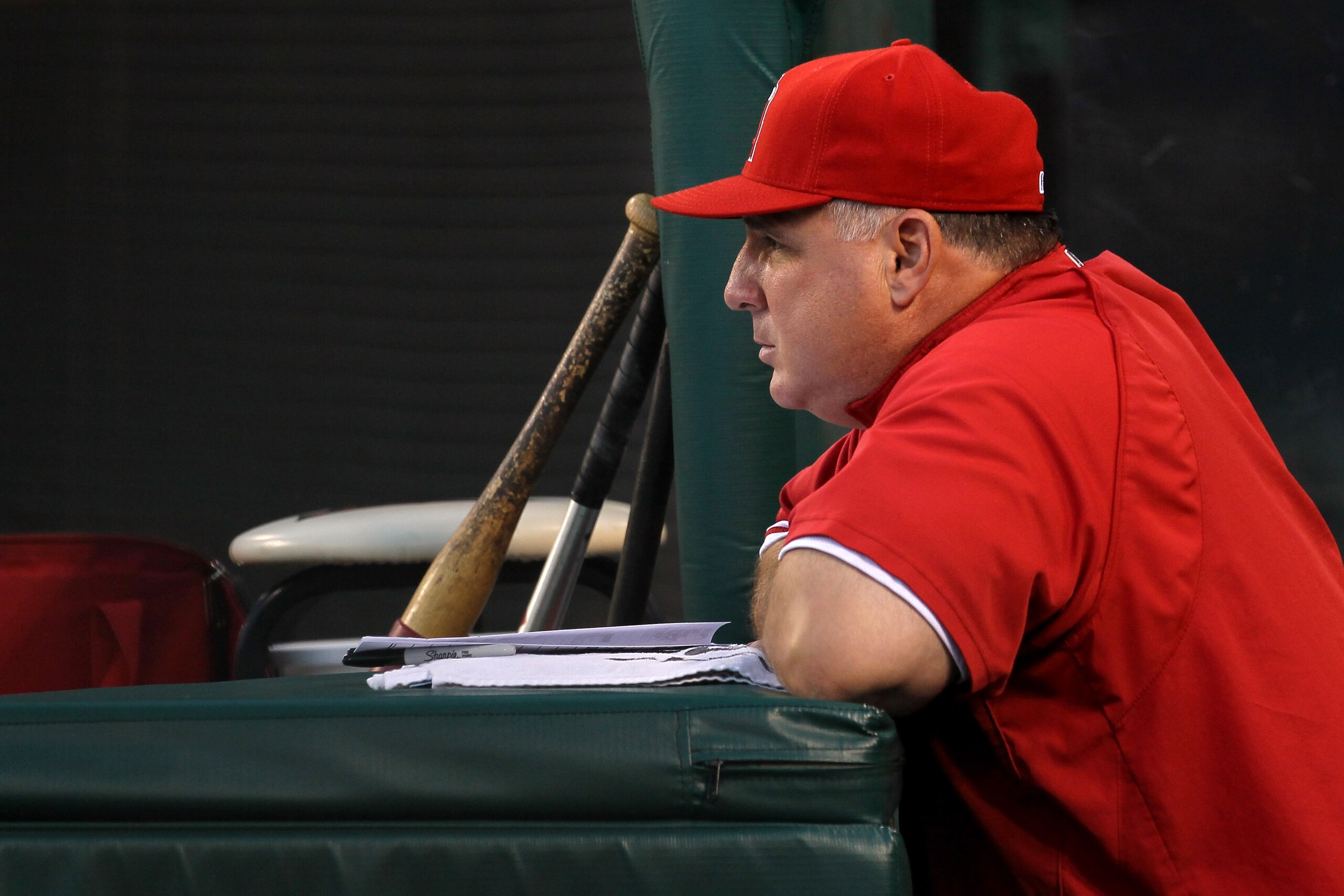 ANAHEIM, CA - JULY 27:  Manager Mike Scioscia of the Los Angeles Angels of Anaheim looks on from the dugout during the game with the Boston Red Sox on July 27, 2010 at Angel Stadium in Anaheim, California.  (Photo by Stephen Dunn/Getty Images)