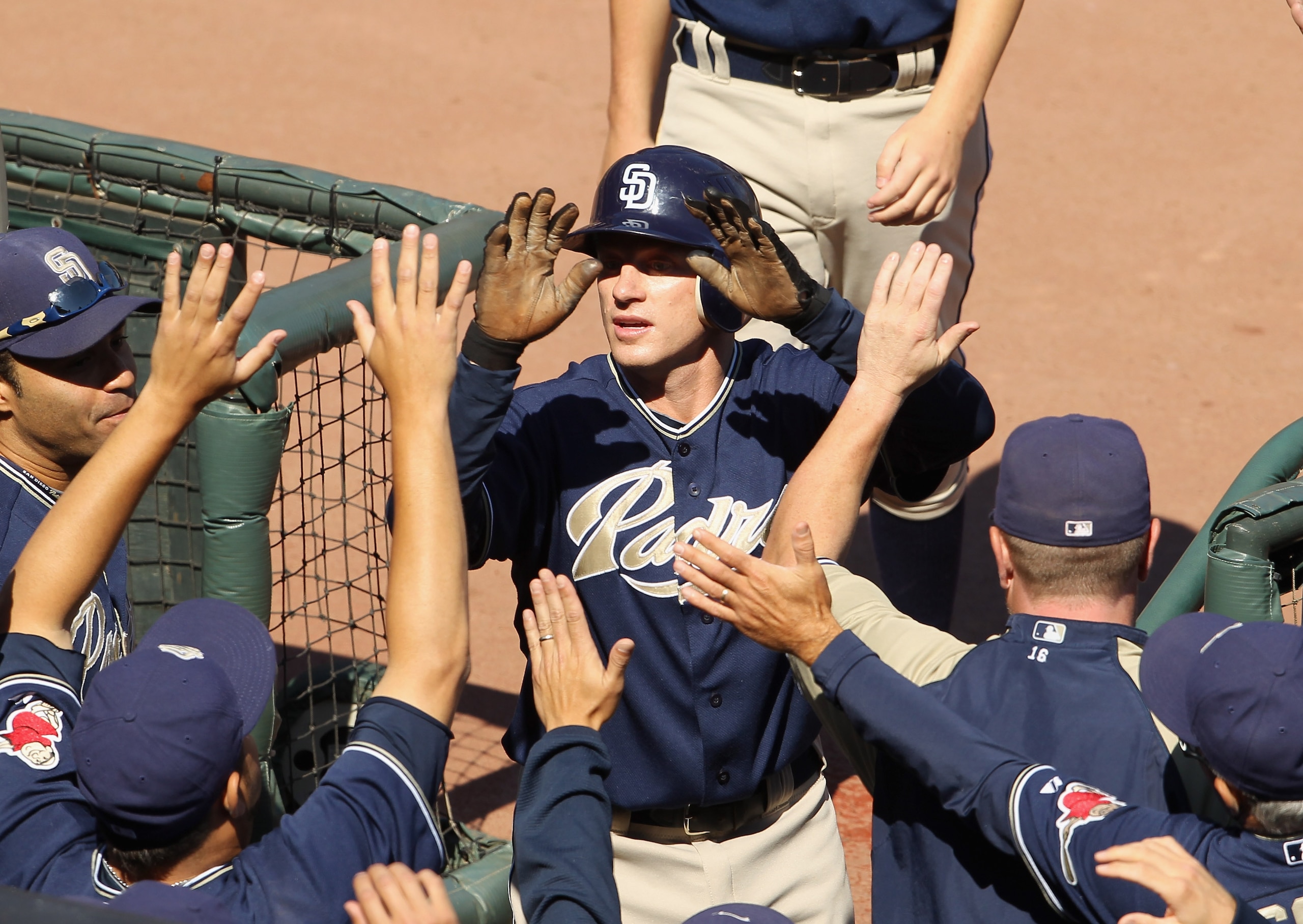 SAN FRANCISCO - OCTOBER 02:  David Eckstein #22 of the San Diego Padres is congratulated by teammates after he scored on a walk to give the Padres a 2-0 lead over the San Francisco Giants in the first inning at AT&T Park on October 2, 2010 in San Francisc