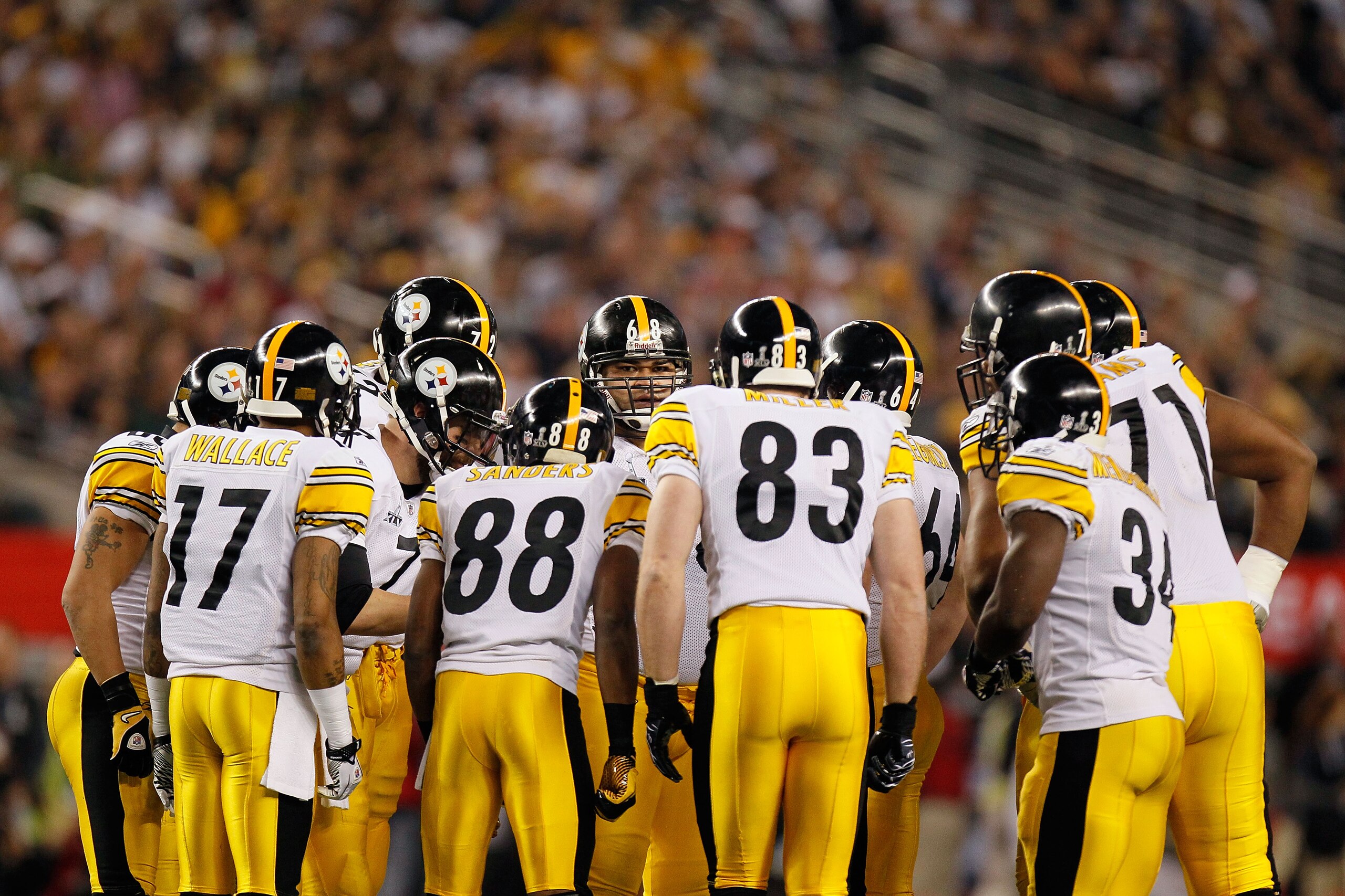 ARLINGTON, TX - FEBRUARY 06: Mike Wallace #17, Emmanuel Sanders #88, Heath Miller #83 and Rashard Mendenhall #34 of the Pittsburgh Steelers huddle with teammates against the Green Bay Packers during Super Bowl XLV at Cowboys Stadium on February 6, 2011 in