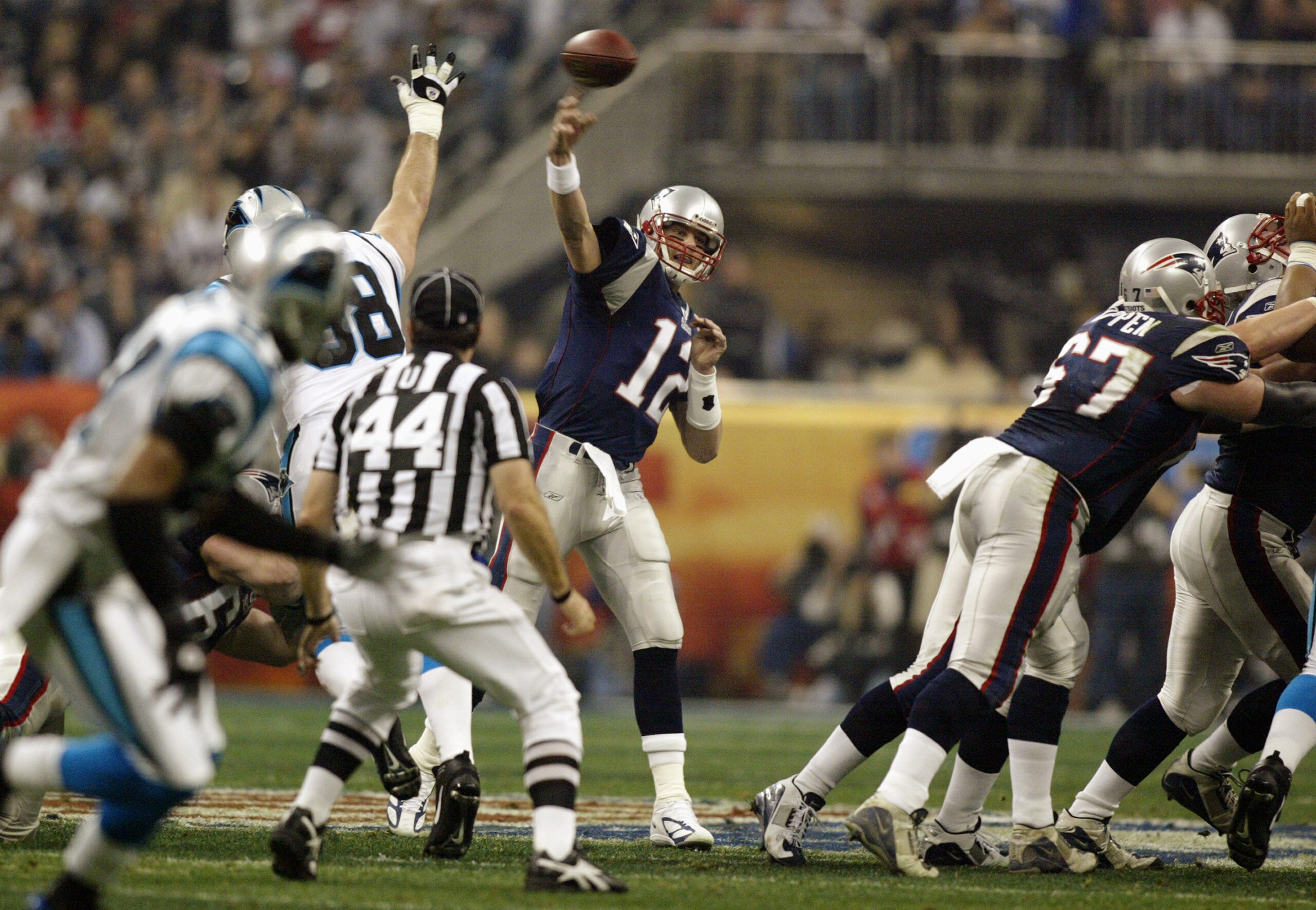 HOUSTON, TX - FEBRUARY 1:  Quarterback Tom Brady #12 of the New England Patriots throws the ball against the Carolina Panthers during Super Bowl XXXVIII at Reliant Stadium on February 1, 2004 in Houston, Texas. The Patriots won 32-29 to claim their second
