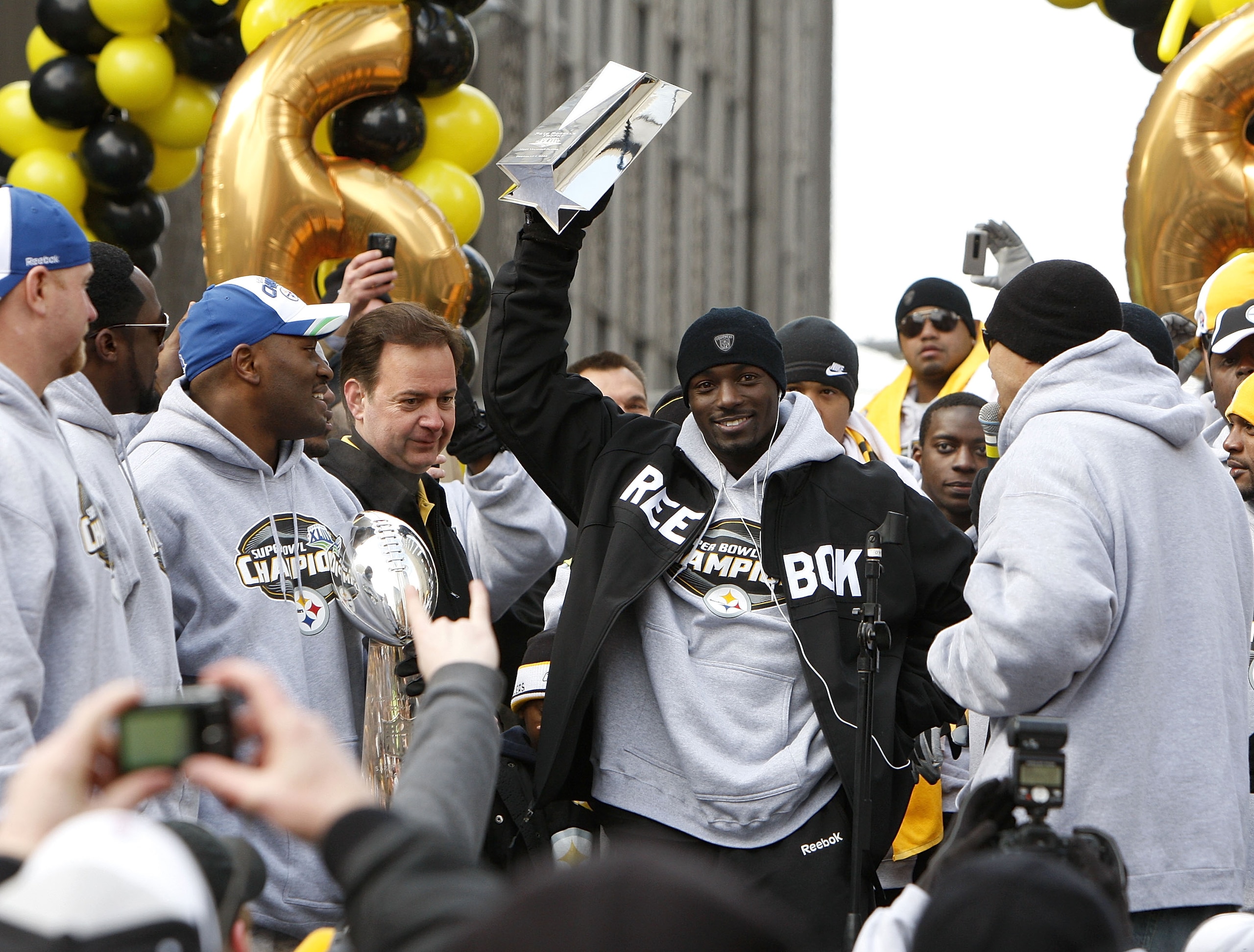 PITTSBURGH - FEBRUARY 03:  Santonio Holmes #10 of the Pittsburgh Steelers during holds up his MVP trophy during a parade to celebrate winning Super Bowl XLIII on February 3, 2009 in Pittsburgh, Pennsylvania.  (Photo by Gregory Shamus/Getty Images)