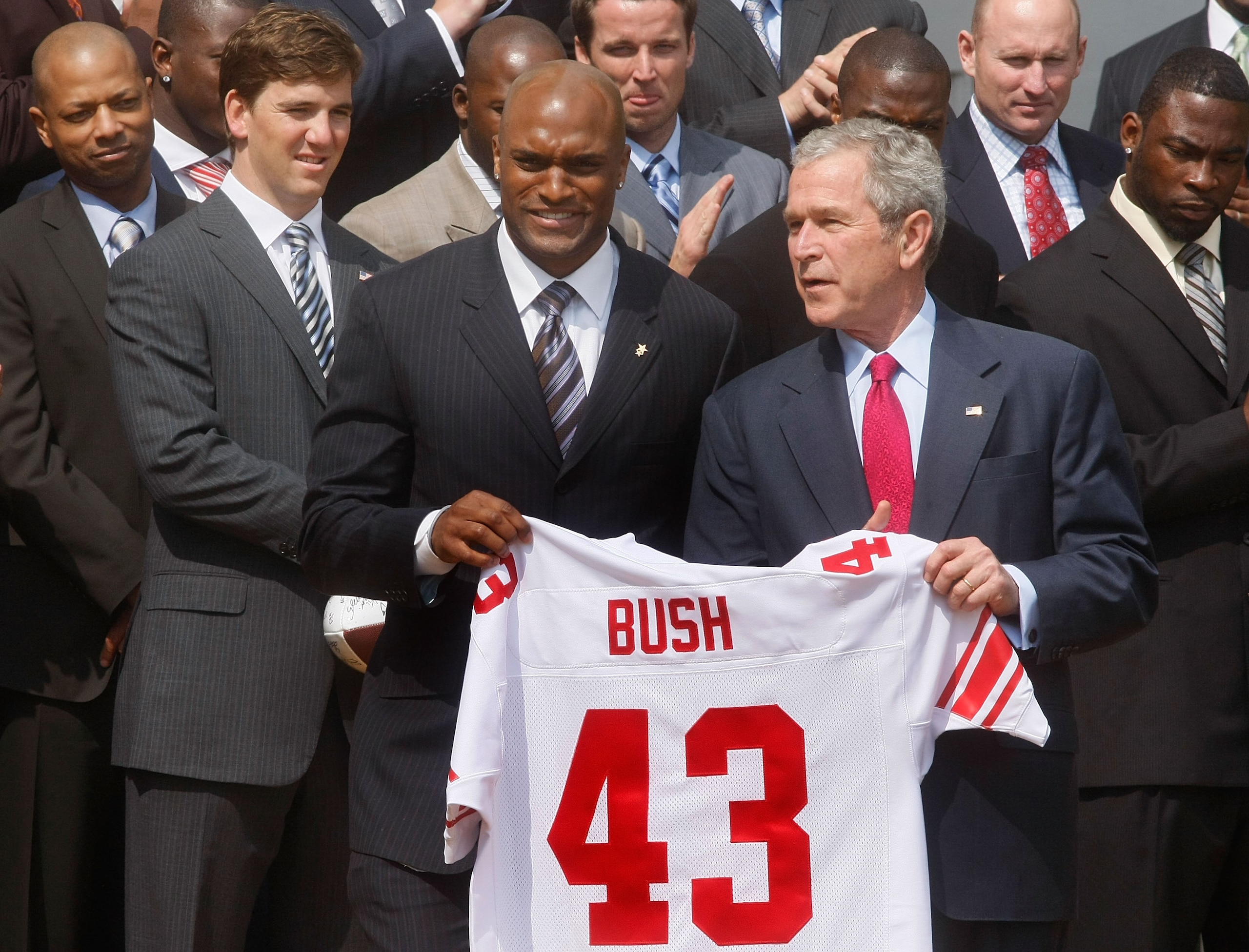 WASHINGTON - APRIL 30: New York Giants wide receiver Amani Toomer (C) presents President George W. Bush (R) with a football jersey during a event to honor the Super bowl XLII Champion New York Giants on the south lawn of the White House, April 30, 2008 in