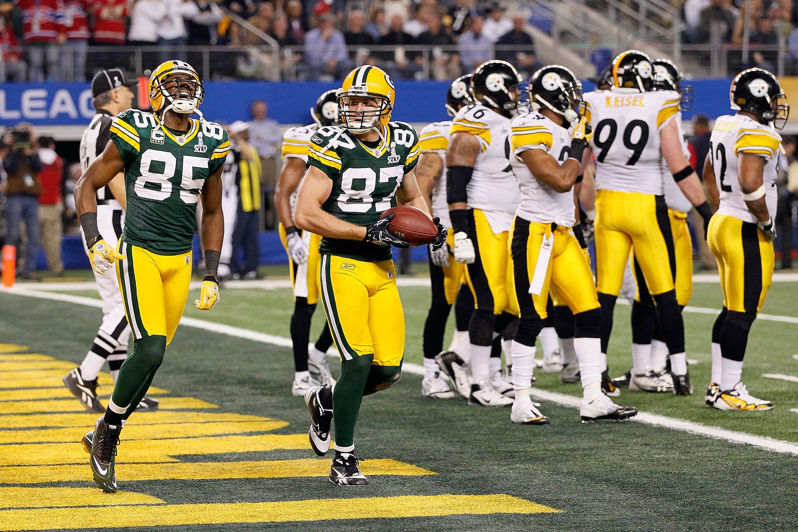 ARLINGTON, TX - FEBRUARY 06: Jordy Nelson #87 and Greg Jennings #85 of the Green Bay Packers celebrate after a late touchdown against the Pittsburgh Steelers during Super Bowl XLV at Cowboys Stadium on February 6, 2011 in Arlington, Texas.  (Photo by Kevi