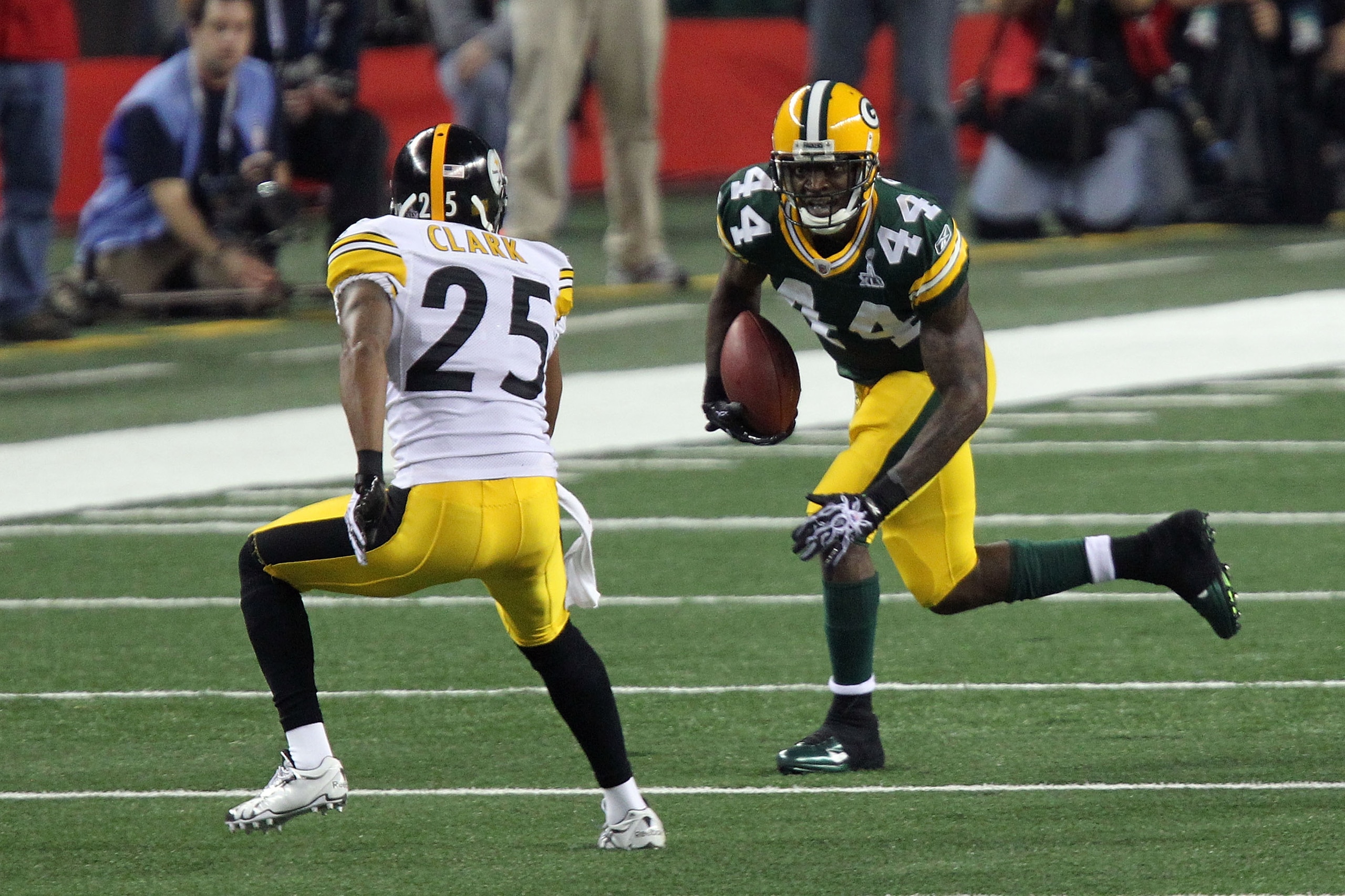 ARLINGTON, TX - FEBRUARY 06: James Starks #44 of the Green Bay Packers runs the ball against Ryan Clark #25 of the Pittsburgh Steelers during the first quarter of Super Bowl XLV at Cowboys Stadium on February 6, 2011 in Arlington, Texas.  (Photo by Mike E