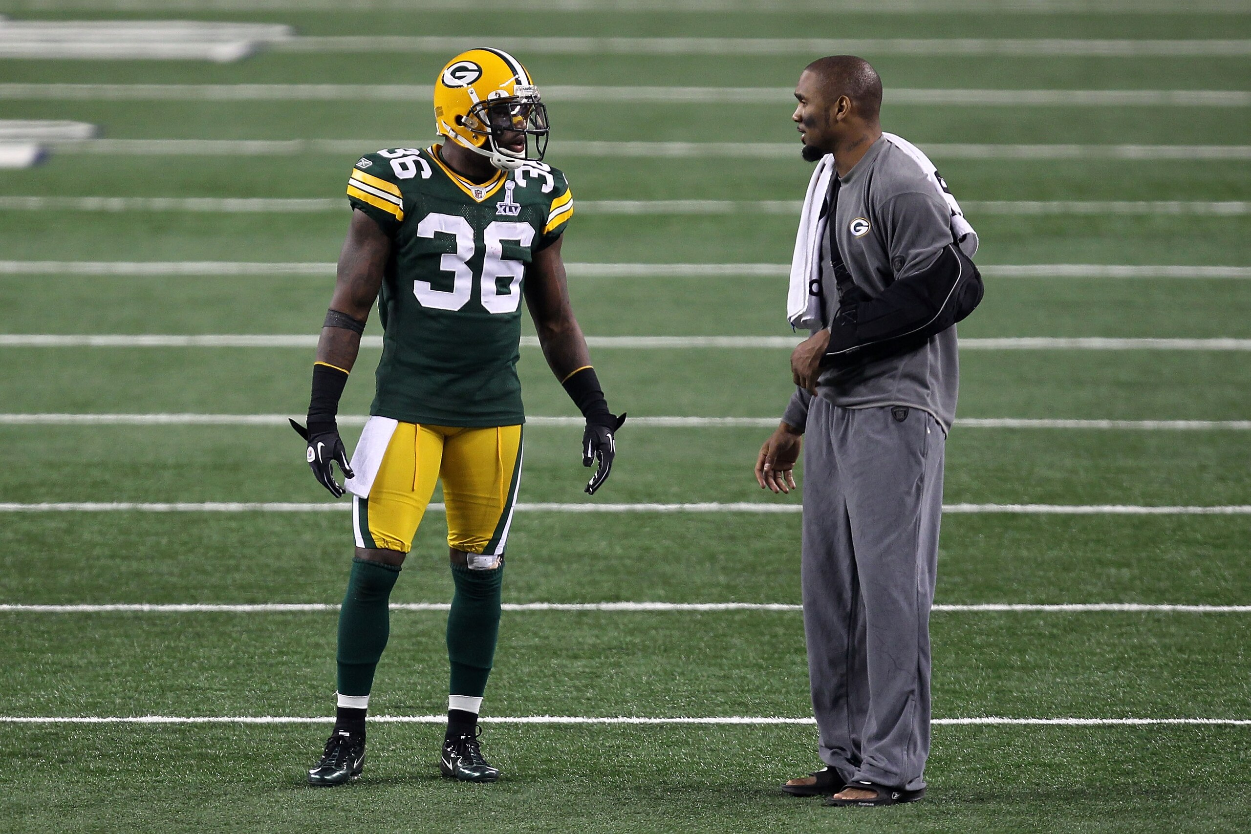 ARLINGTON, TX - FEBRUARY 06: Nick Collins #36 of the Green Bay Packers talks with injured teammate Charles Woodson during Super Bowl XLV at Cowboys Stadium on February 6, 2011 in Arlington, Texas.  (Photo by Mike Ehrmann/Getty Images)