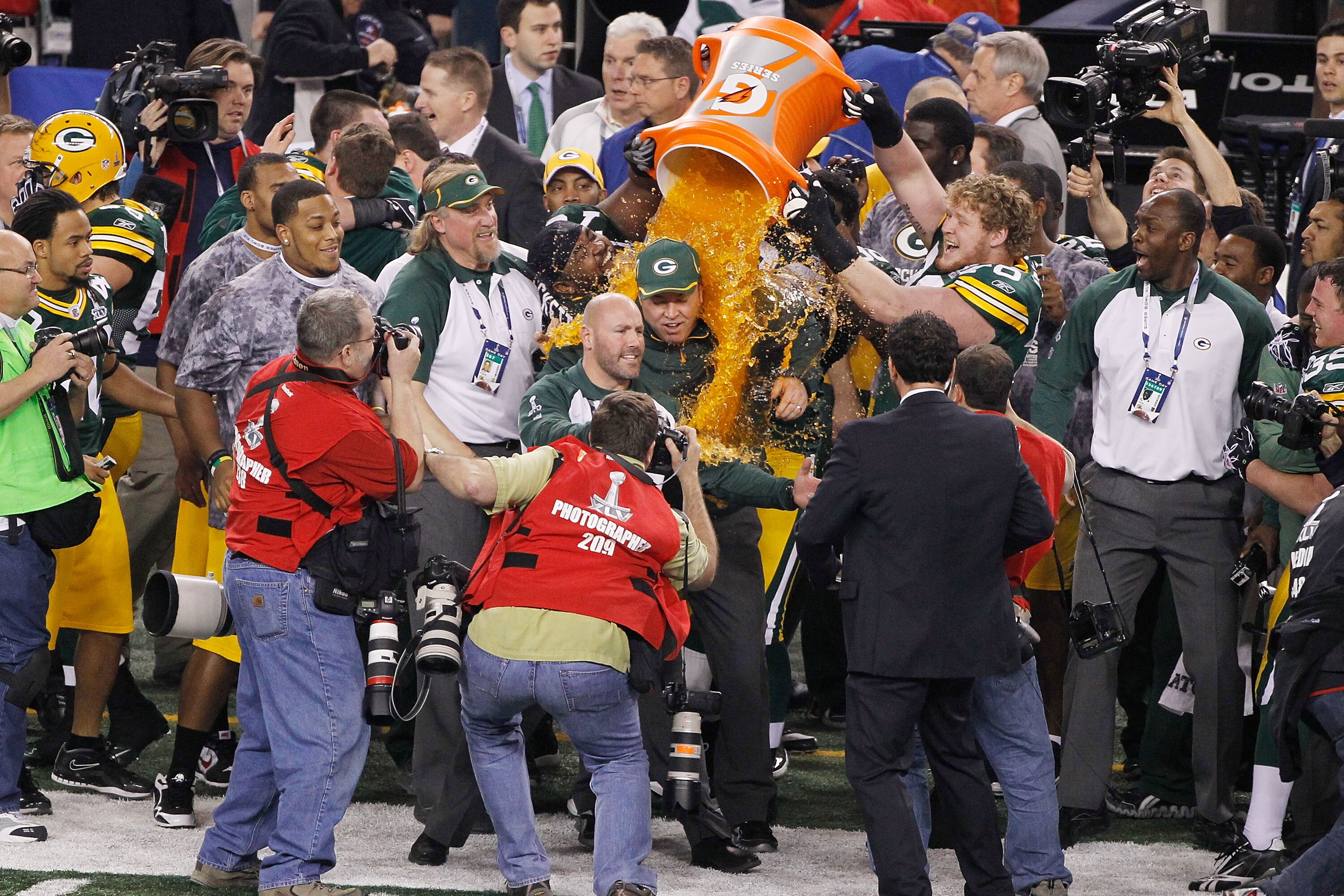 ARLINGTON, TX - FEBRUARY 06:  C.J. Wilson #98, T.J. Lang #70 and Ryan Pickett #79 of the Green Bay Packers dump Gatorade on head coach Mike McCarthy after they defeated the Pittsburgh Steelers 31 to 25 in Super Bowl XLV at Cowboys Stadium on February 6, 2