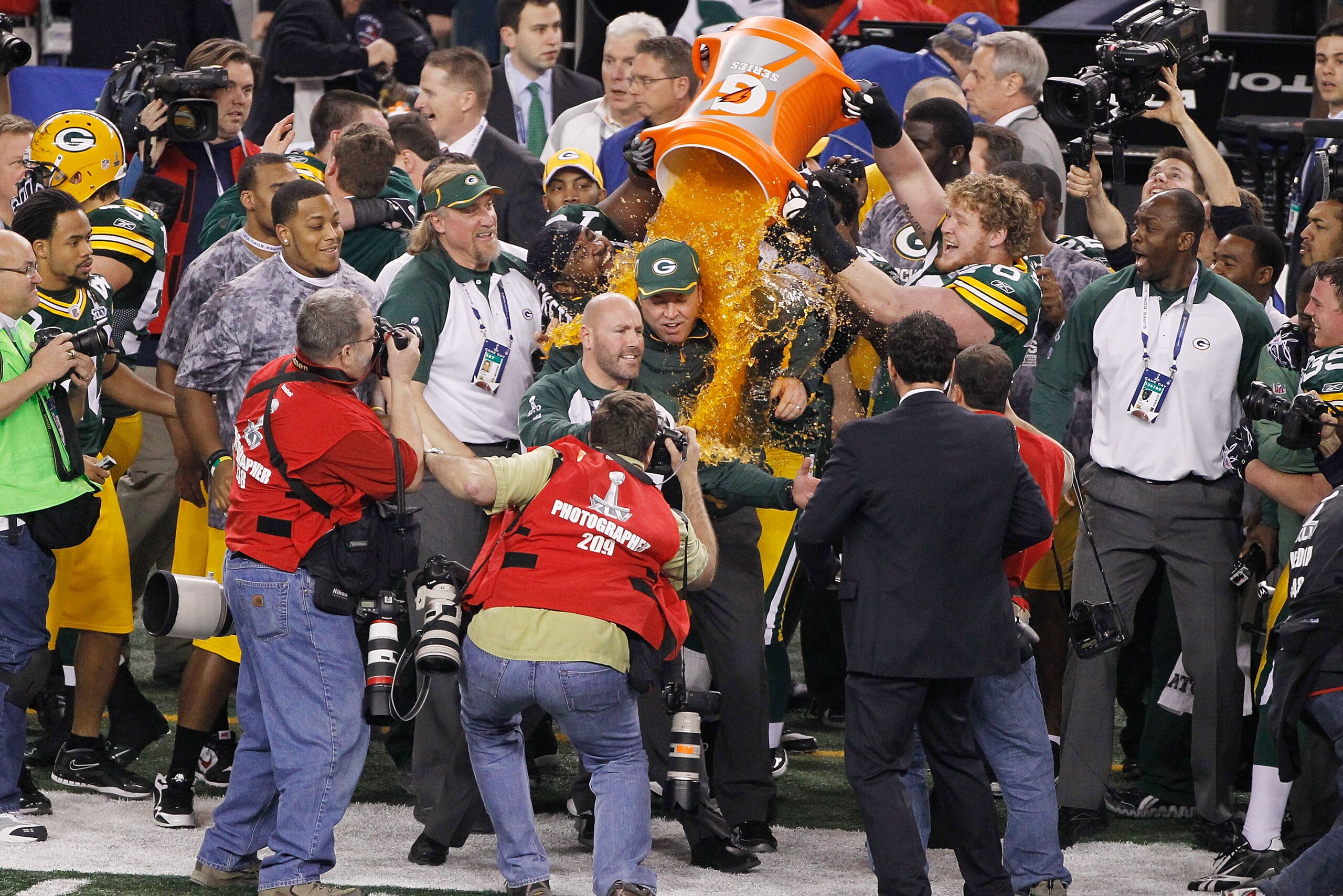 ARLINGTON, TX - FEBRUARY 06:  C.J. Wilson #98, T.J. Lang #70 and Ryan Pickett #79 of the Green Bay Packers dump Gatorade on head coach Mike McCarthy after they defeated the Pittsburgh Steelers 31 to 25 in Super Bowl XLV at Cowboys Stadium on February 6, 2