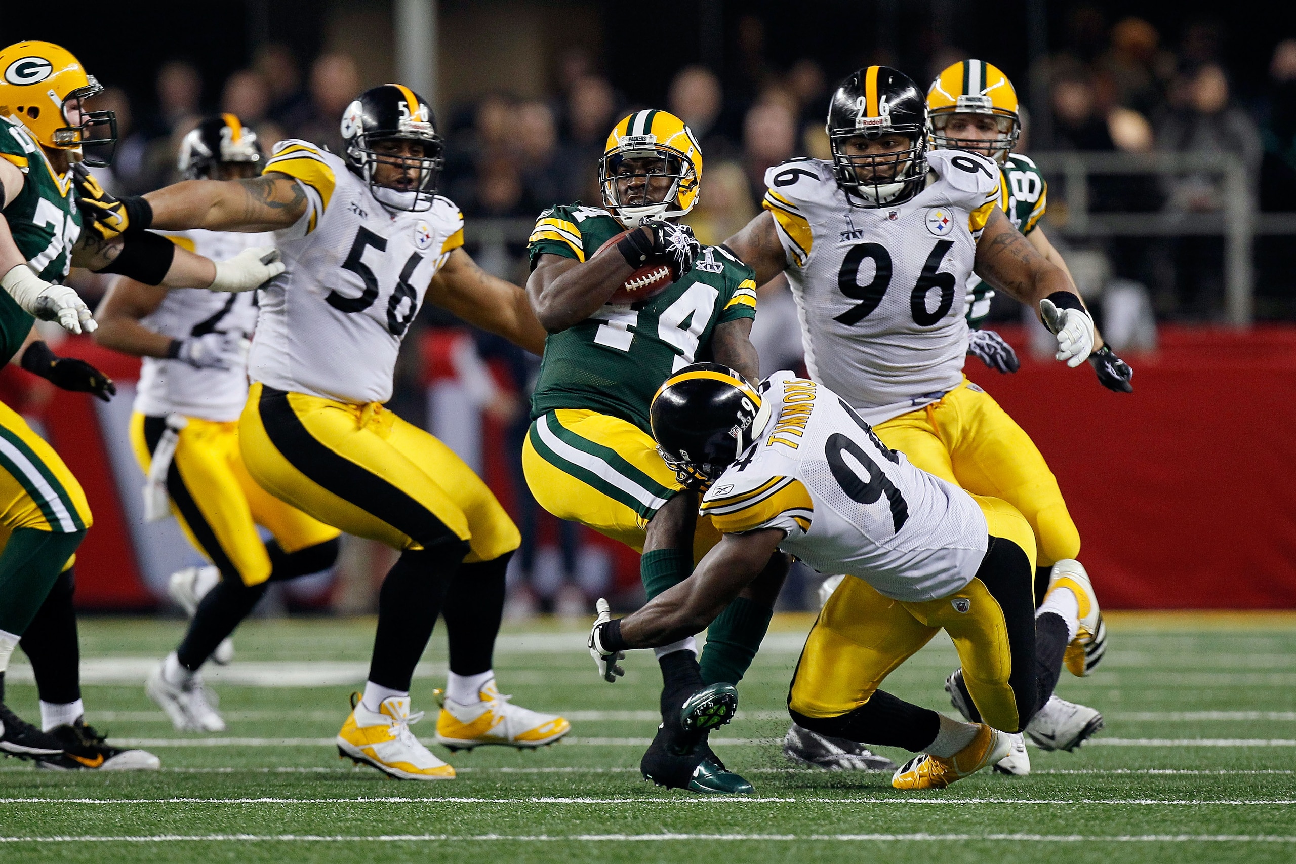ARLINGTON, TX - FEBRUARY 06: James Starks #44 of the Green Bay Packers is tackled by Lawrence Timmons #94 and LaMarr Woodley #56 of the Pittsburgh Steelers during Super Bowl XLV at Cowboys Stadium on February 6, 2011 in Arlington, Texas.  (Photo by Kevin 