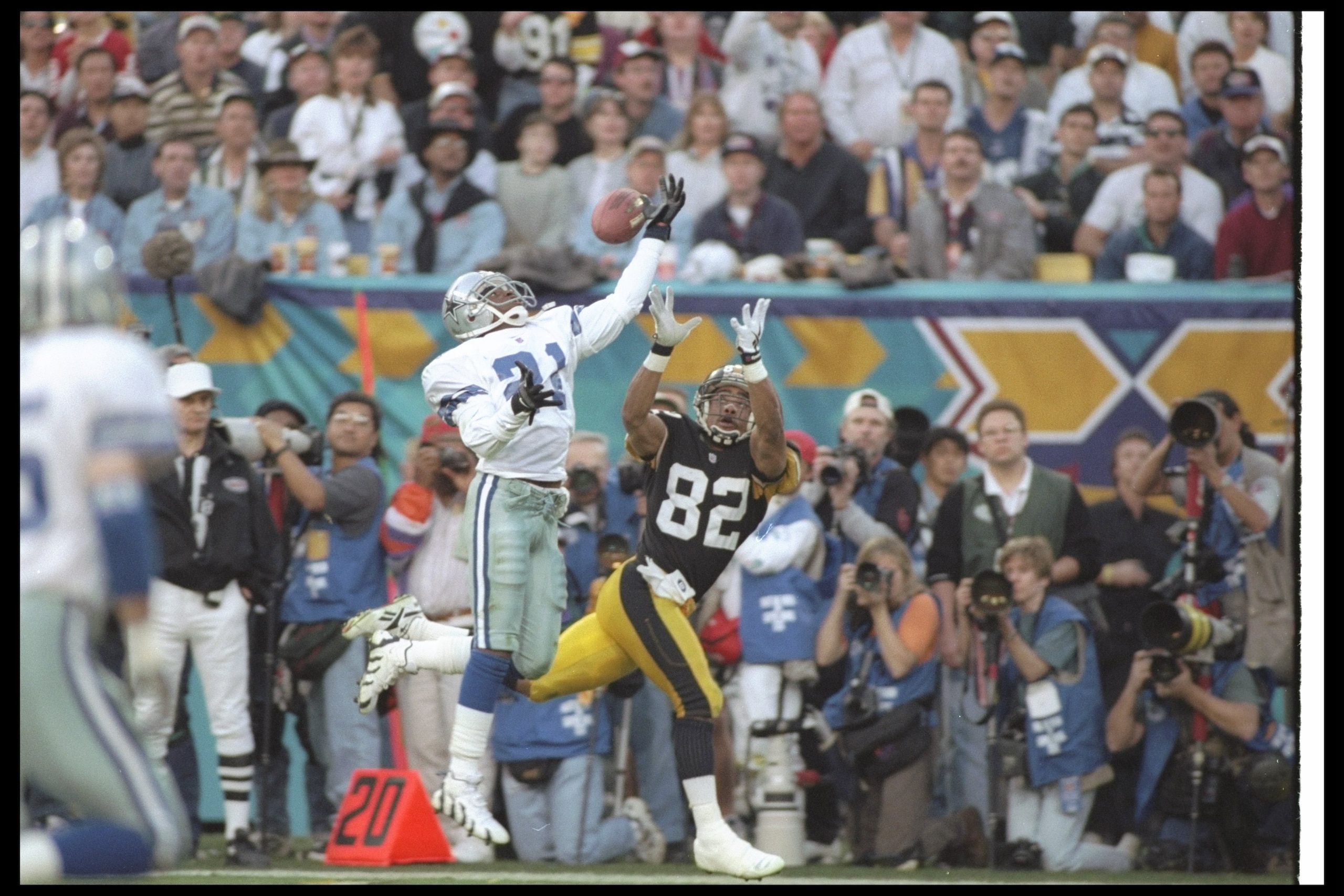 28 Jan 1996:  Defensive back Deion Sanders of the Dallas Cowboys (left) breaks up a pass intended for Pittsburgh Steelers wide receiver Yancey Thigpen during Super Bowl XXX at Sun Devil Stadium in Tempe, Arizona.  The Cowboys won the game, 27-17. Mandator