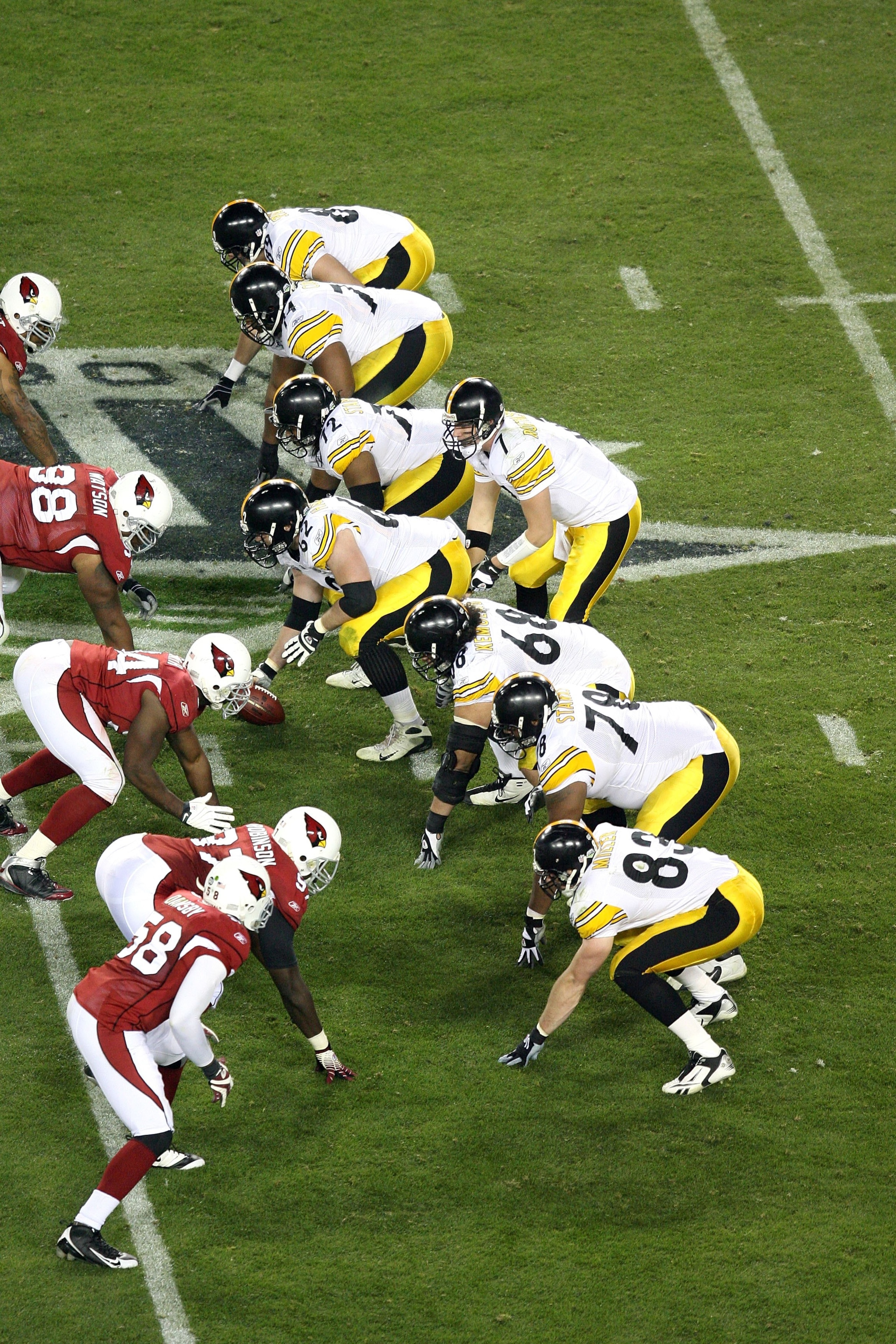TAMPA, FL - FEBRUARY 01:  Quarterback Ben Roethlisberger #7 of the Pittsburgh Steelers stands at the line behind (top to bottom) Matt Spaeth #89, Willie Colon #74, Darnell Stapleton #72, Justin Hartwig #62, Chris Kemoeatu #68, Max Starks #78 and Heath Mil