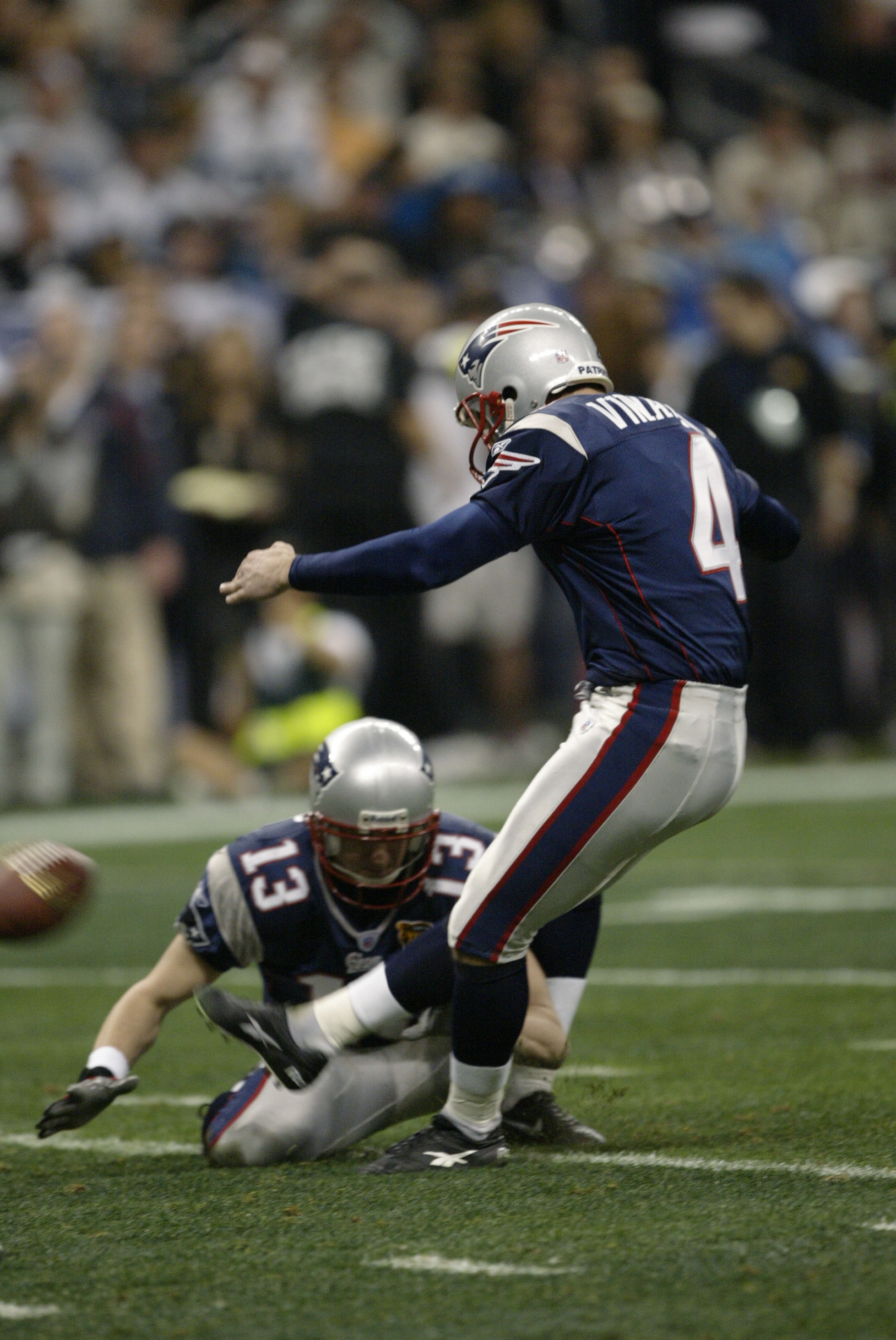 HOUSTON - FEBRUARY 1:  Kicker Adam Vinatieri #4 of the New England Patriots attempts to score off a hold from punter Ken Walter #13 during Super Bowl XXXVIII against the Carolina Panthers at Reliant Stadium on February 1, 2004 in Houston, Texas.  The Patr