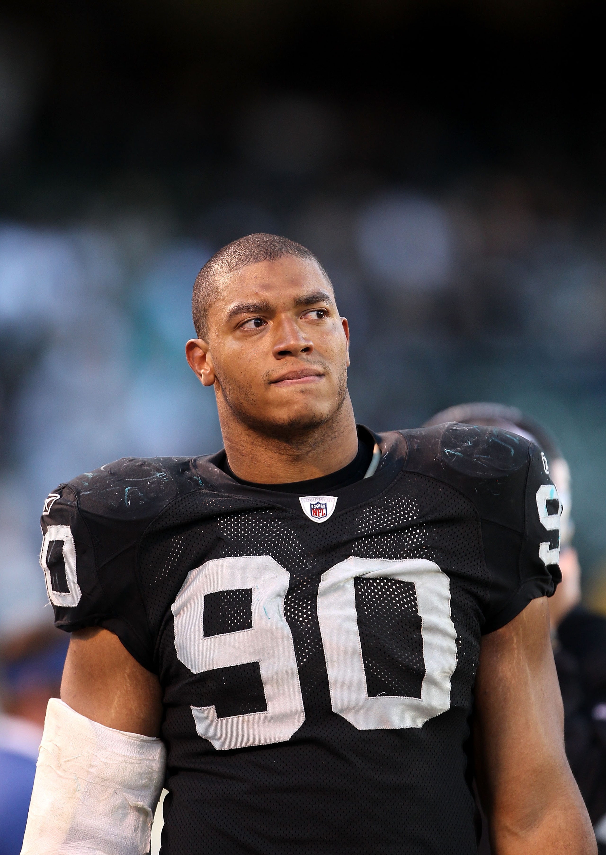 OAKLAND, CA - NOVEMBER 28:  Desmond Bryant #90 of the Oakland Raiders stands on the sidelines during the closing minutes of their loss to the Miami Dolphins at Oakland-Alameda County Coliseum on November 28, 2010 in Oakland, California.  (Photo by Ezra Sh