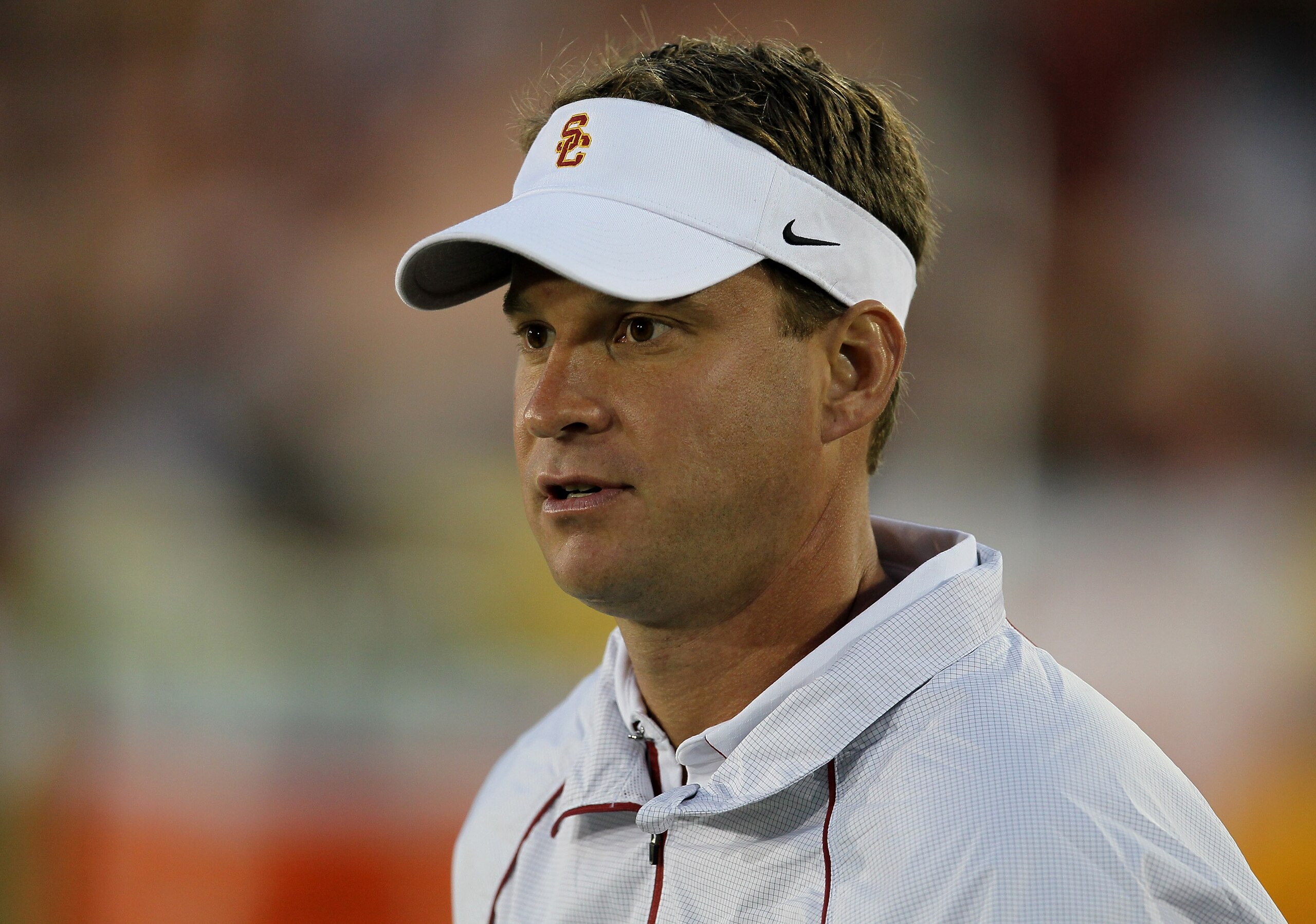 LOS ANGELES, CA - SEPTEMBER 11:  Head coach Lane Kiffin watches the USC Trojans warm up for their game with the Virginia Cavaliers at Los Angeles Memorial Coliseum on September 11, 2010 in Los Angeles, California.  (Photo by Stephen Dunn/Getty Images)