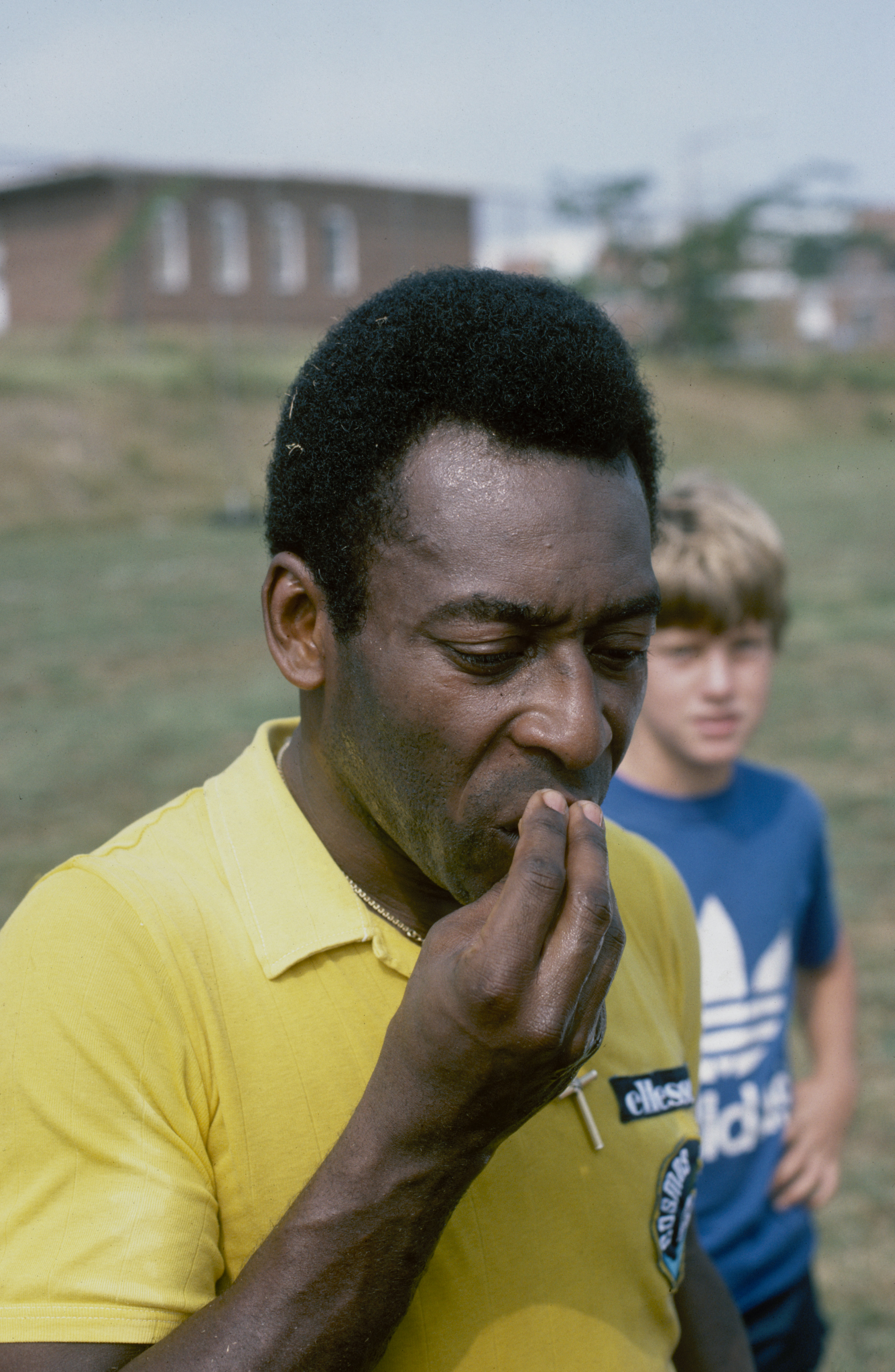 Brazilian footballer Pele kisses his hand during a training session, mid 1970s. (Photo by Duncan Raban/Getty Images)