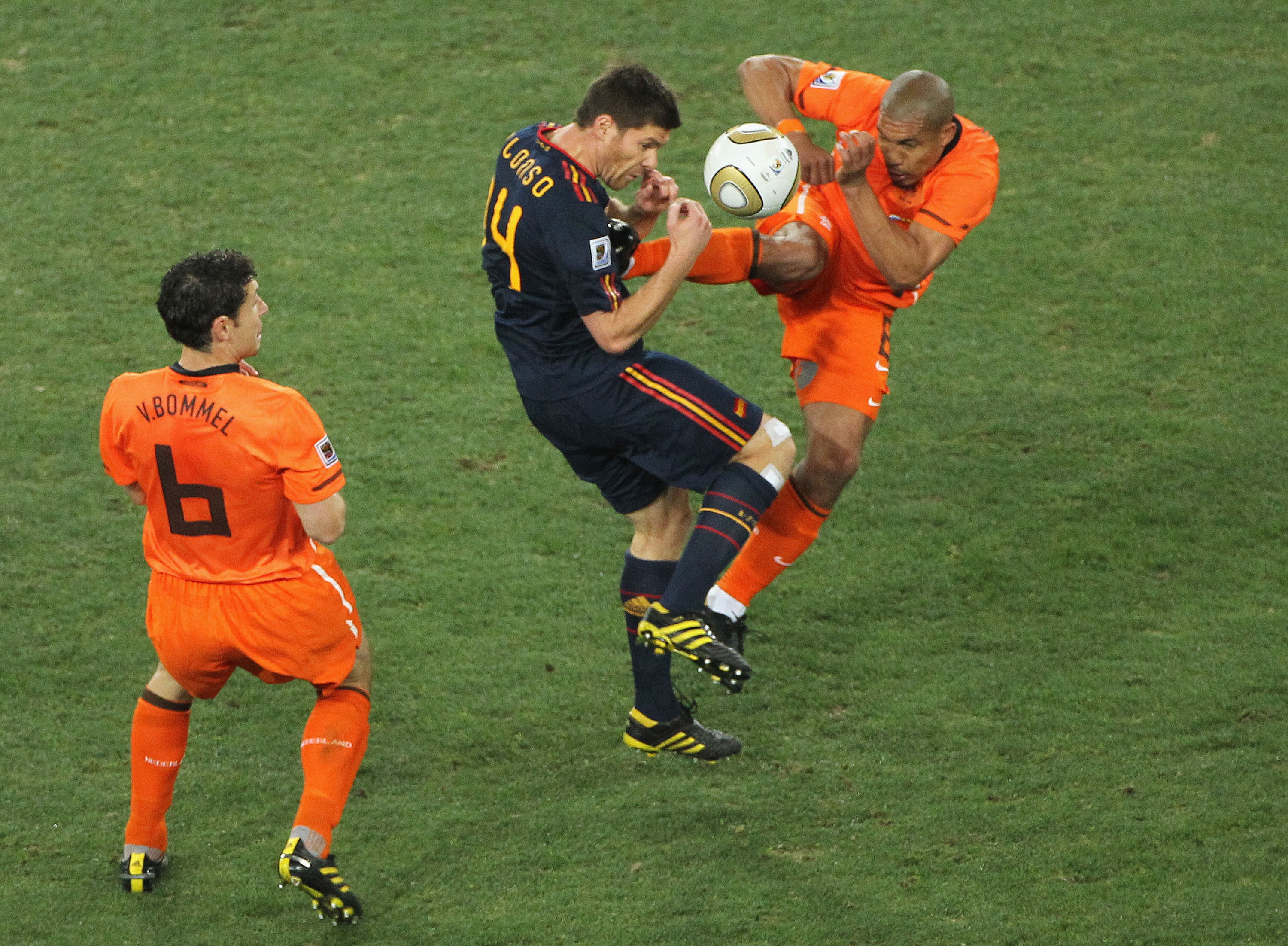 JOHANNESBURG, SOUTH AFRICA - JULY 11:  Nigel De Jong of the Netherlands tackles Xabi Alonso of Spain with a kick in the chest during the 2010 FIFA World Cup South Africa Final match between Netherlands and Spain at Soccer City Stadium on July 11, 2010 in