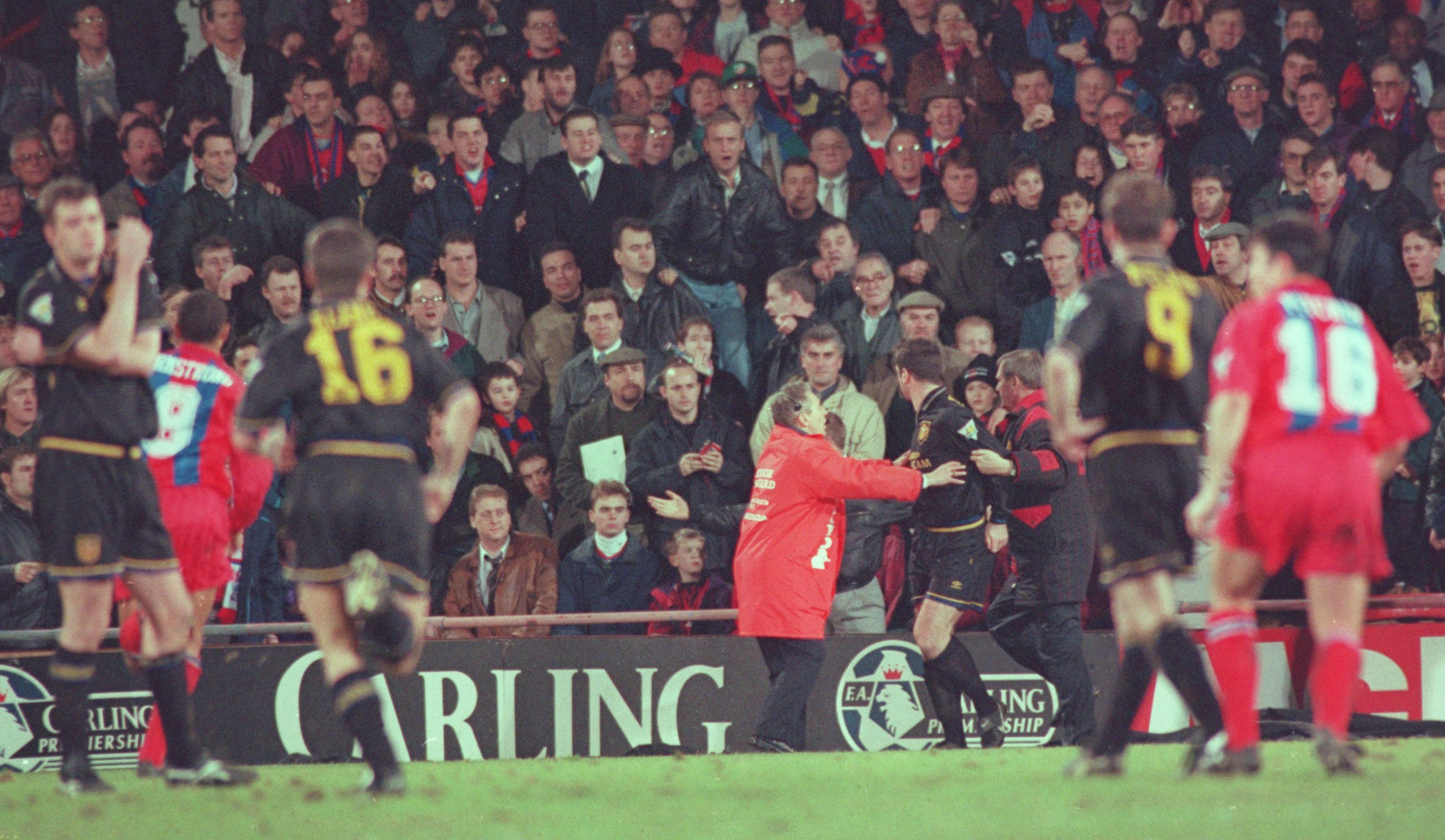 25 JAN 1995:  ERIC CANTONA OF MANCHESTER UNITED IS INVOLVED IN A FIGHT WITH A FAN AFTER HE WAS SENT OFF DURING THE CRYSTAL PALACE V MANCHESTER UNITED MATCH AT SELHURST PARK. Mandatory Credit: Shaun Botterill/ALLSPORT