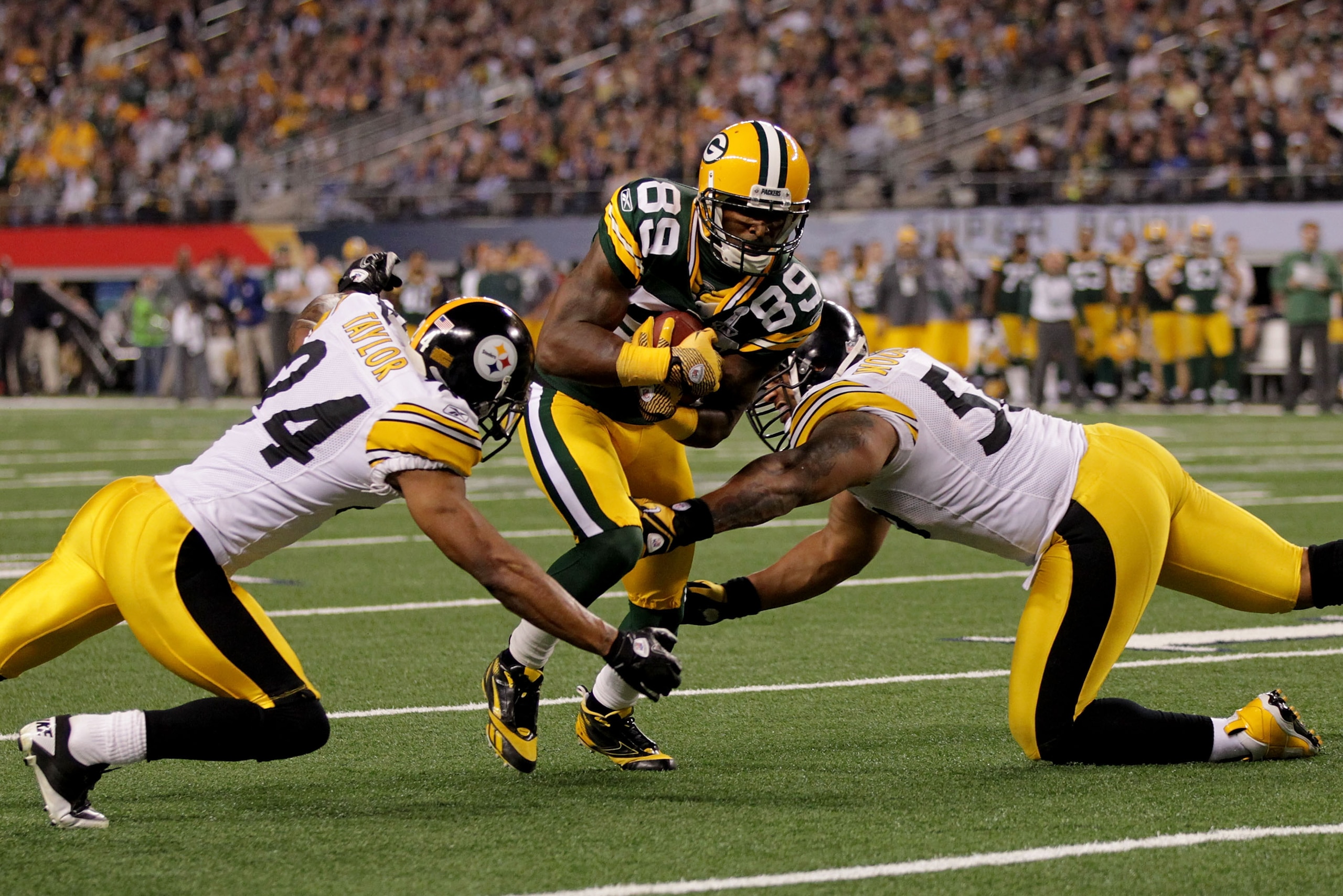 ARLINGTON, TX - FEBRUARY 06: James Jones #89 of the Green Bay Packers tries to avoid the tackle of LaMarr Woodley #56 and Ike Taylor #24 of the Pittsburgh Steelers and during Super Bowl XLV at Cowboys Stadium on February 6, 2011 in Arlington, Texas. (Ph ARLINGTON, TX - FEBRUARY 06: James Jones #89 of the Green Bay Packers tries to avoid the tackle of LaMarr Woodley #56 and Ike Taylor #24 of the Pittsburgh Steelers and during Super Bowl XLV at Cowboys Stadium on February 6, 2011 in Arlington, Texas. (Ph