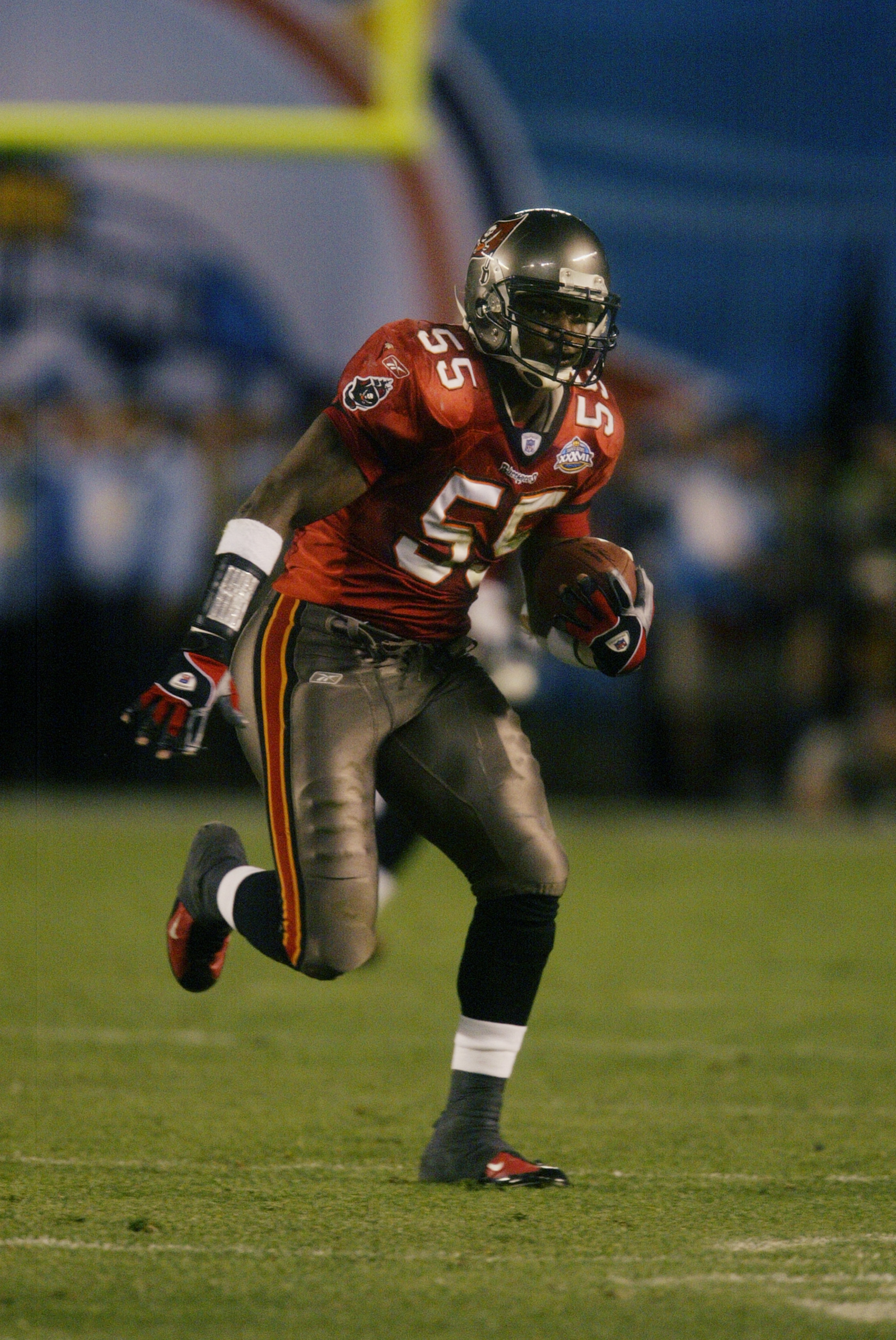 SAN DIEGO - JANUARY 26: Linebacker Derrick Brooks #55 of the Tampa Bay Buccaneers picks up a fumble by Oakland Raiders quarterback Rich Gannon and runs it in for a fourth quarter touchdown during Super Bowl XXXVII at Qualcomm Stadium on January 26, 2003 SAN DIEGO - JANUARY 26: Linebacker Derrick Brooks #55 of the Tampa Bay Buccaneers picks up a fumble by Oakland Raiders quarterback Rich Gannon and runs it in for a fourth quarter touchdown during Super Bowl XXXVII at Qualcomm Stadium on January 26, 2003
