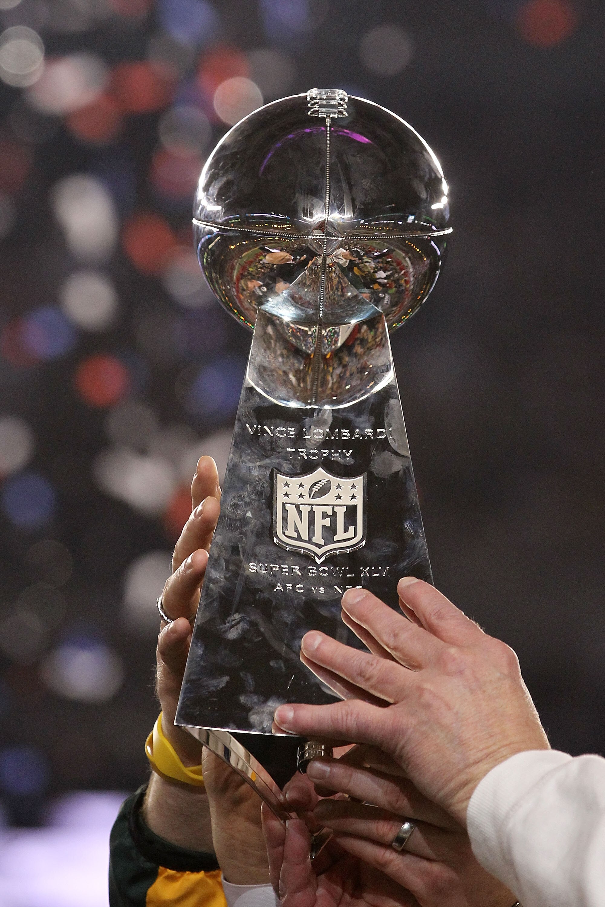 ARLINGTON, TX - FEBRUARY 06:  The Green Bay Packers hold up The Vince Lombardi Trophy after the defeating the Pittsburgh Steelers 31 to 25 in Super Bowl XLV at Cowboys Stadium on February 6, 2011 in Arlington, Texas.  (Photo by Ronald Martinez/Getty Image