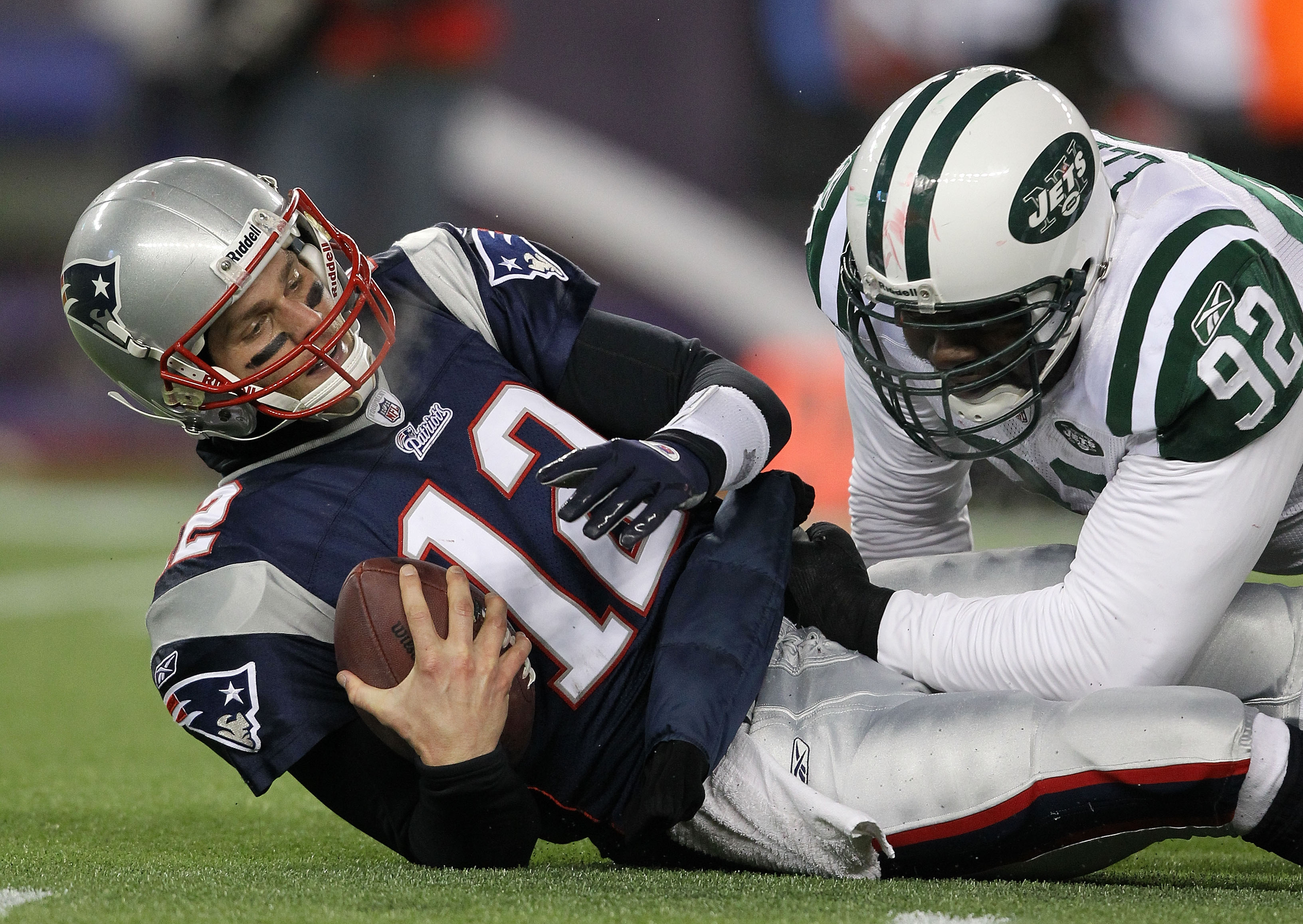 FOXBORO, MA - JANUARY 16:  Quarterback Tom Brady #12 of the New England Patriots is sacked by Shaun Ellis #92 of the New York Jets during their 2011 AFC divisional playoff game at Gillette Stadium on January 16, 2011 in Foxboro, Massachusetts.  (Photo by 