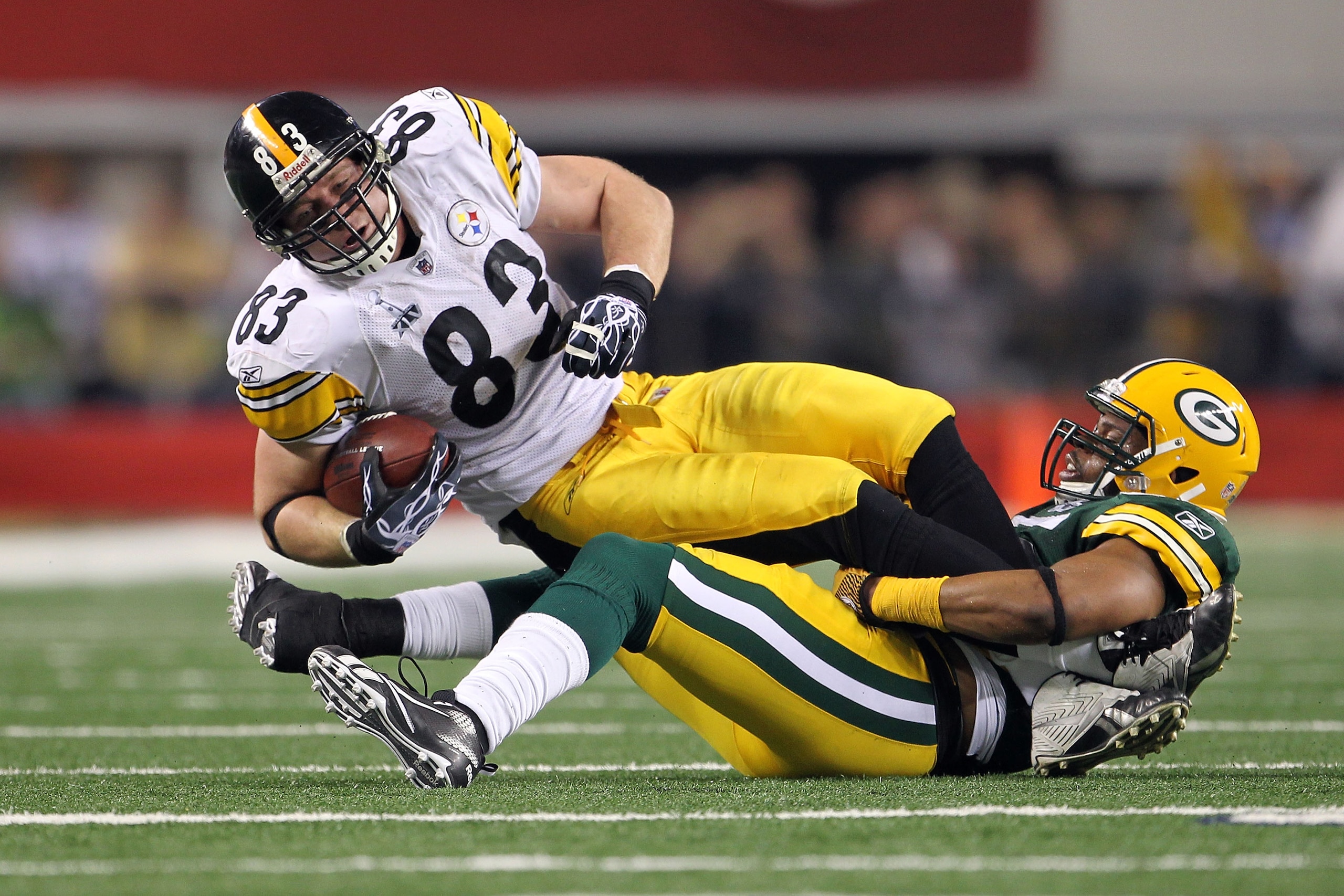 ARLINGTON, TX - FEBRUARY 06: Heath Miller #83 of the Pittsburgh Steelers is tackled after a catch by Desmond Bishop #55 of the Green Bay Packers during Super Bowl XLV at Cowboys Stadium on February 6, 2011 in Arlington, Texas.  (Photo by Jamie Squire/Gett