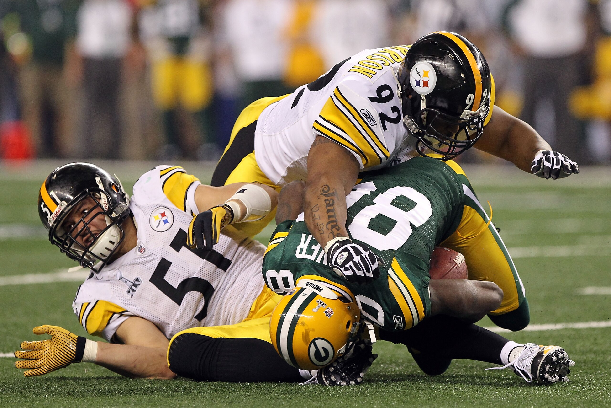 ARLINGTON, TX - FEBRUARY 06:  Donald Driver #80 of the Green Bay Packers is tackled by James Farrior #51 and James Harrison #92 of the Pittsburgh Steelers during the second quarter of Super Bowl XLV at Cowboys Stadium on February 6, 2011 in Arlington, Tex