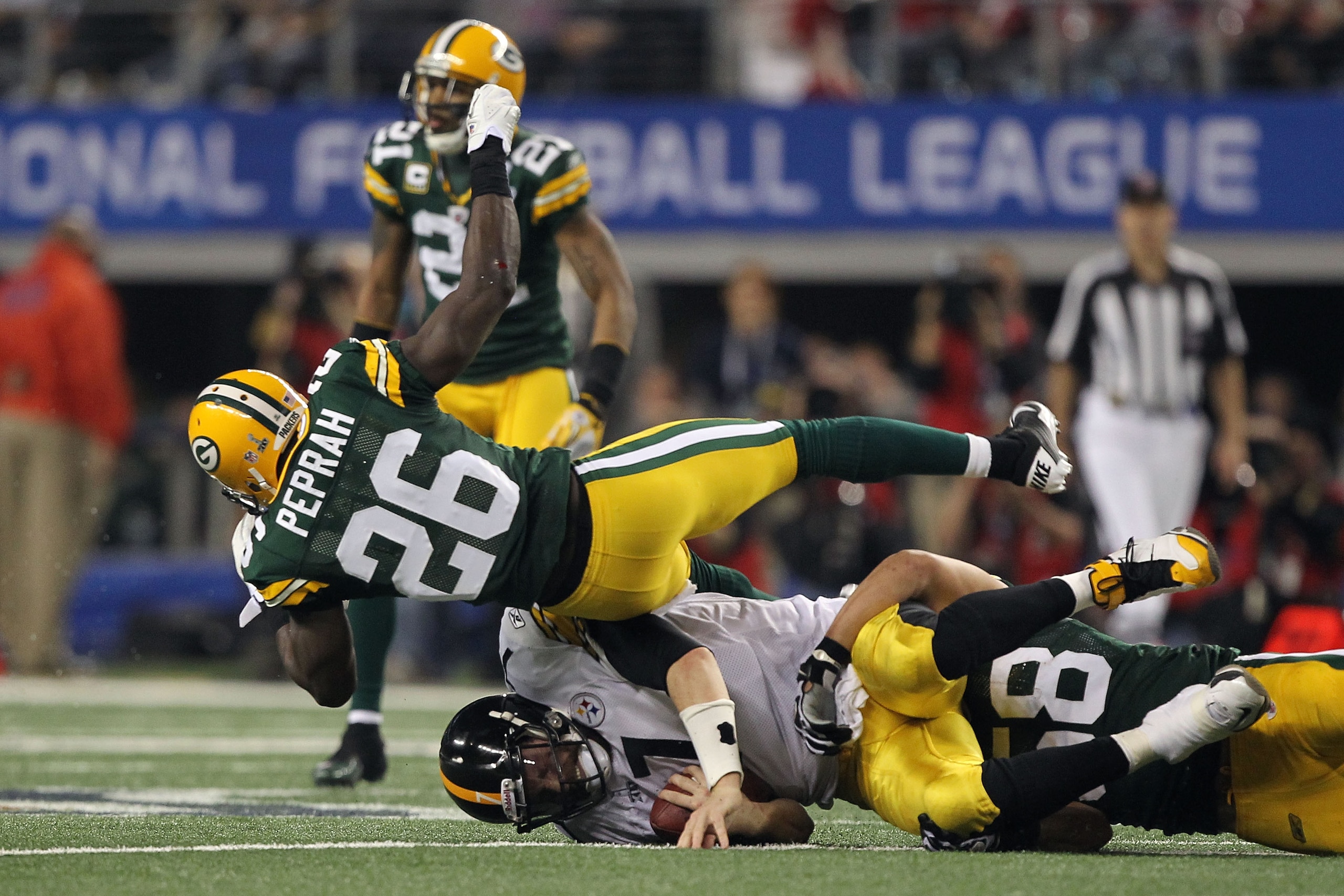 ARLINGTON, TX - FEBRUARY 06: Ben Roethlisberger #7 of the Pittsburgh Steelers is tackled by Charlie Peprah #26 and Frank Zombo #58 of the Green Bay Packers during Super Bowl XLV at Cowboys Stadium on February 6, 2011 in Arlington, Texas.  (Photo by Al Bel