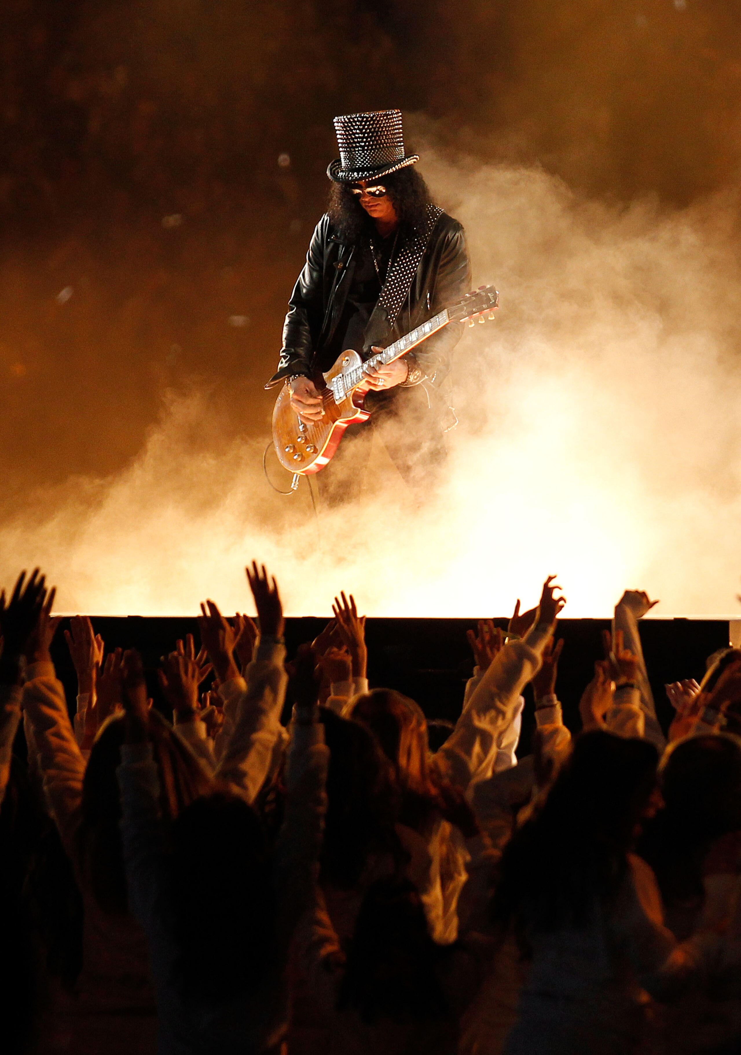 ARLINGTON, TX - FEBRUARY 06:  Slash performs during the Bridgestone Super Bowl XLV Halftime Show at Dallas Cowboys Stadium on February 6, 2011 in Arlington, Texas.  (Photo by Christopher Polk/Getty Images)