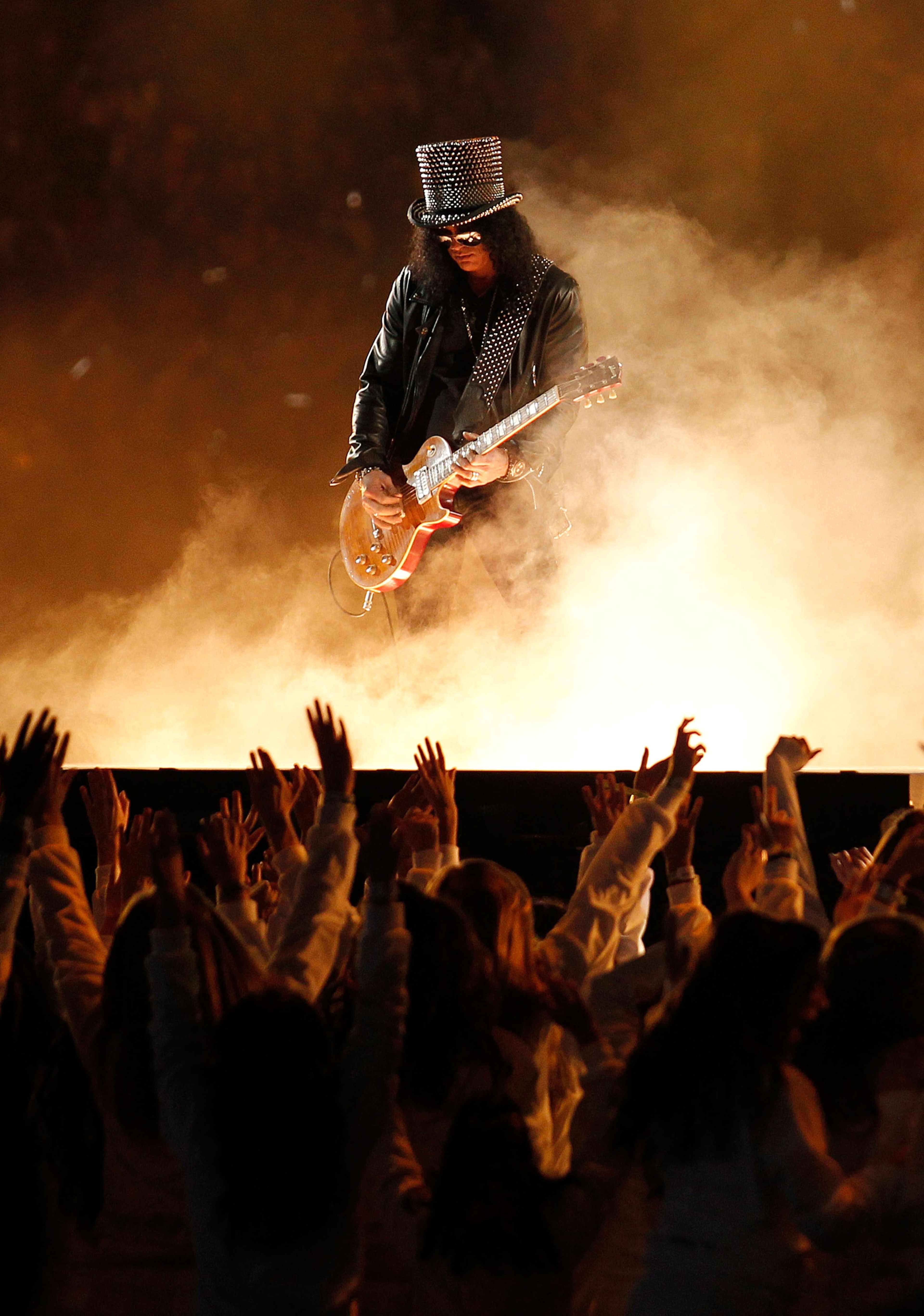 ARLINGTON, TX - FEBRUARY 06:  Slash performs during the Bridgestone Super Bowl XLV Halftime Show at Dallas Cowboys Stadium on February 6, 2011 in Arlington, Texas.  (Photo by Christopher Polk/Getty Images)
