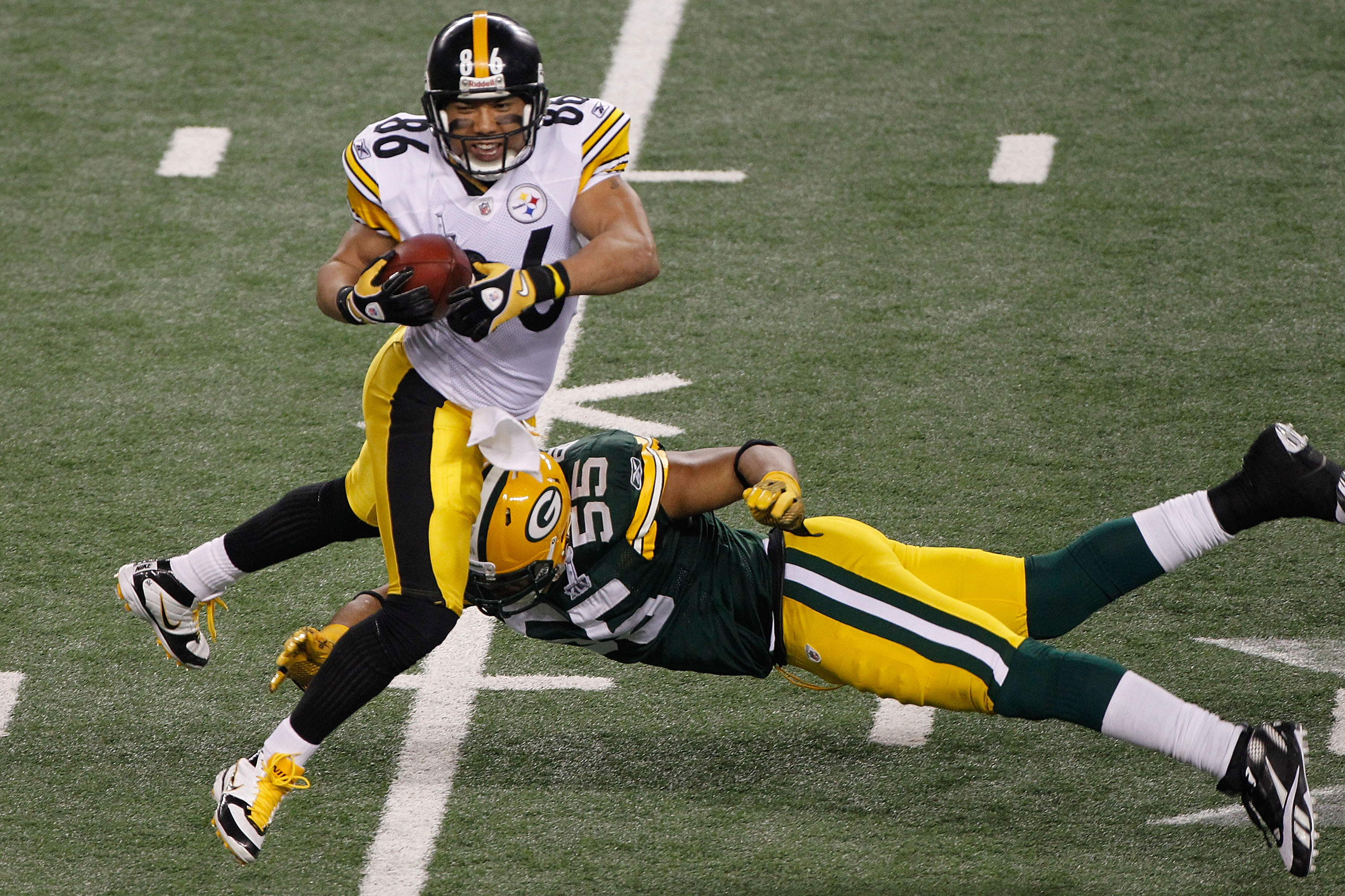 ARLINGTON, TX - FEBRUARY 06:  Hines Ward #86 of the Pittsburgh Steelers tries to avoid the tackle of Desmond Bishop #55 of the Green Bay Packers during Super Bowl XLV at Cowboys Stadium on February 6, 2011 in Arlington, Texas.  (Photo by Joe Robbins/Getty