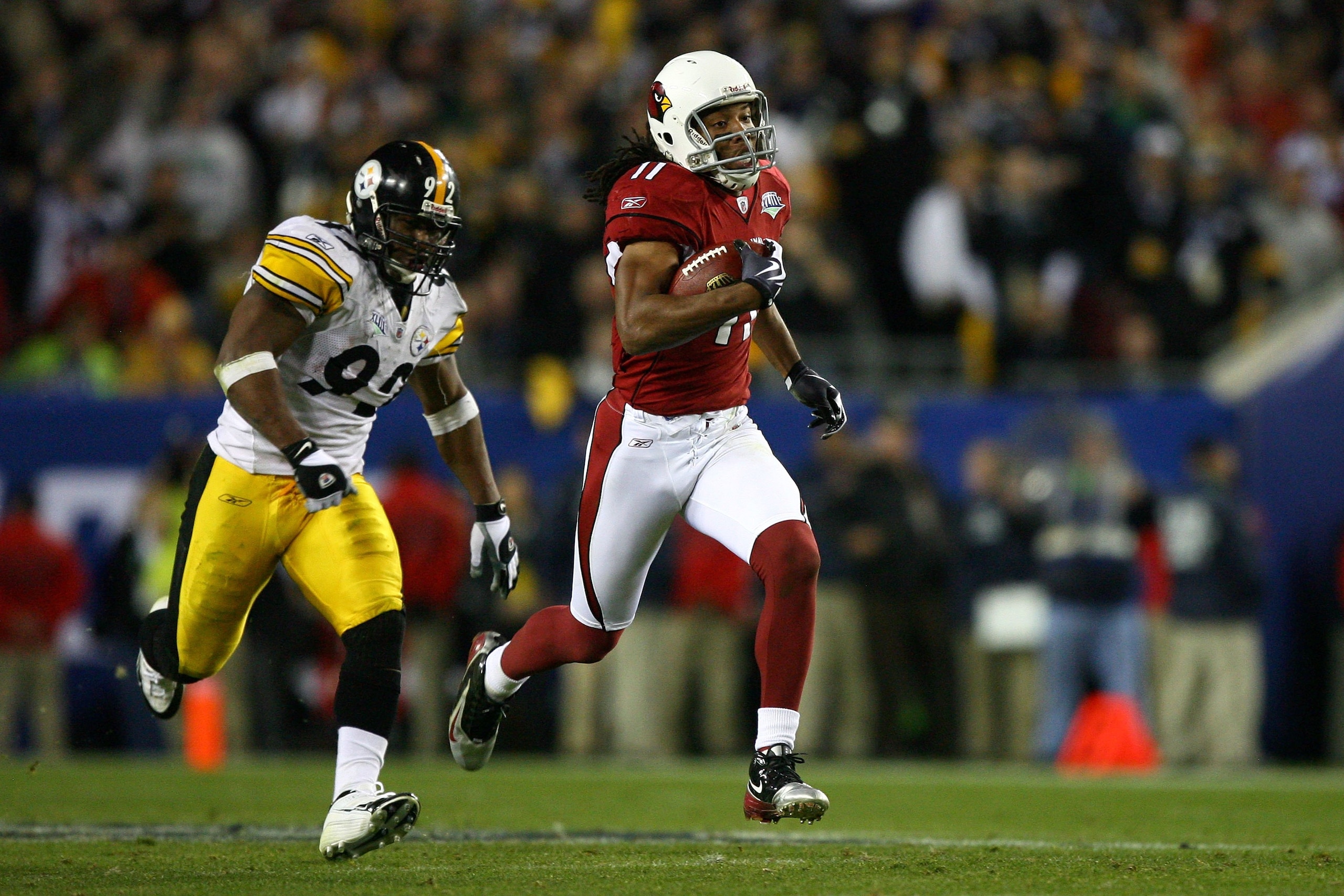 TAMPA, FL - FEBRUARY 01:  Larry Fitzgerald #11 of the Arizona Cardinals runs for yards after the catch on a 64-yard touchdown reception against James Harrison #92 of the Pittsburgh Steelers in the fourth quarter during Super Bowl XLIII on February 1, 2009
