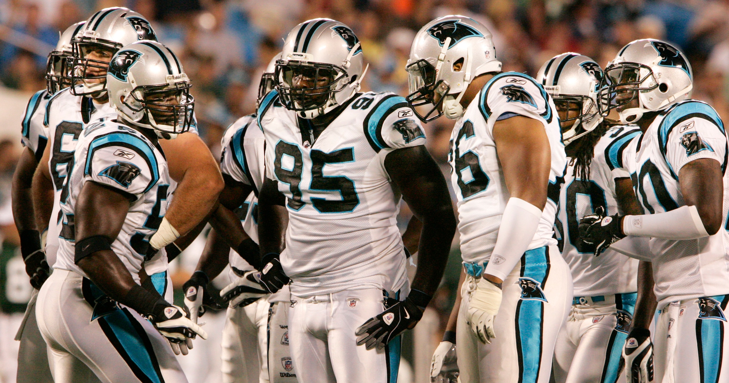 CHARLOTTE, NC - AUGUST 21:  Linebacker Jon Beason  #52, left, of the Carolina Panthers signals to his team during their preseason game against the New York Jets at Bank of America Stadium on August 21, 2010 in Charlotte, North Carolina. (Photo by Mary Ann