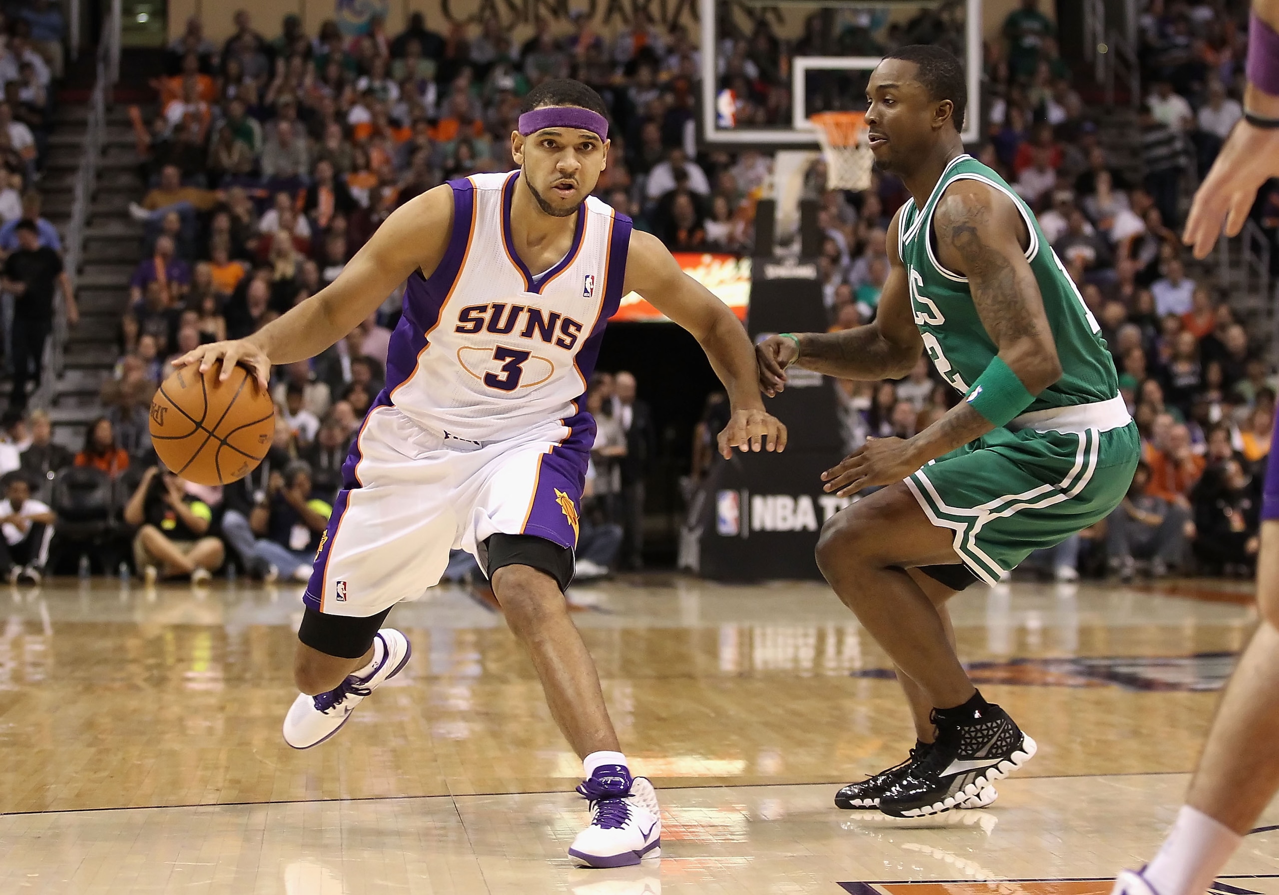 PHOENIX, AZ - JANUARY 28:  Jared Dudley ## of the Phoenix Suns handles the ball under pressure from Von Wafer #12 of the Boston Celtics during the NBA game at US Airways Center on January 28, 2011 in Phoenix, Arizona. The Suns defeated the Celtics 88-71.